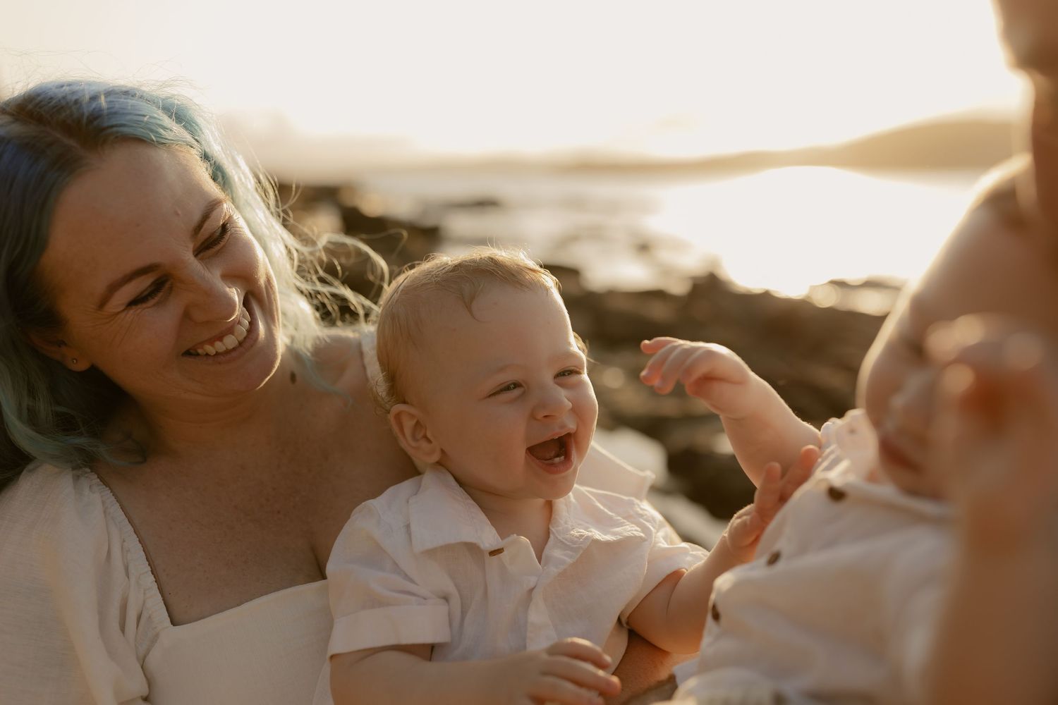 Joyful family moments shared during a sunset beach photoshoot.