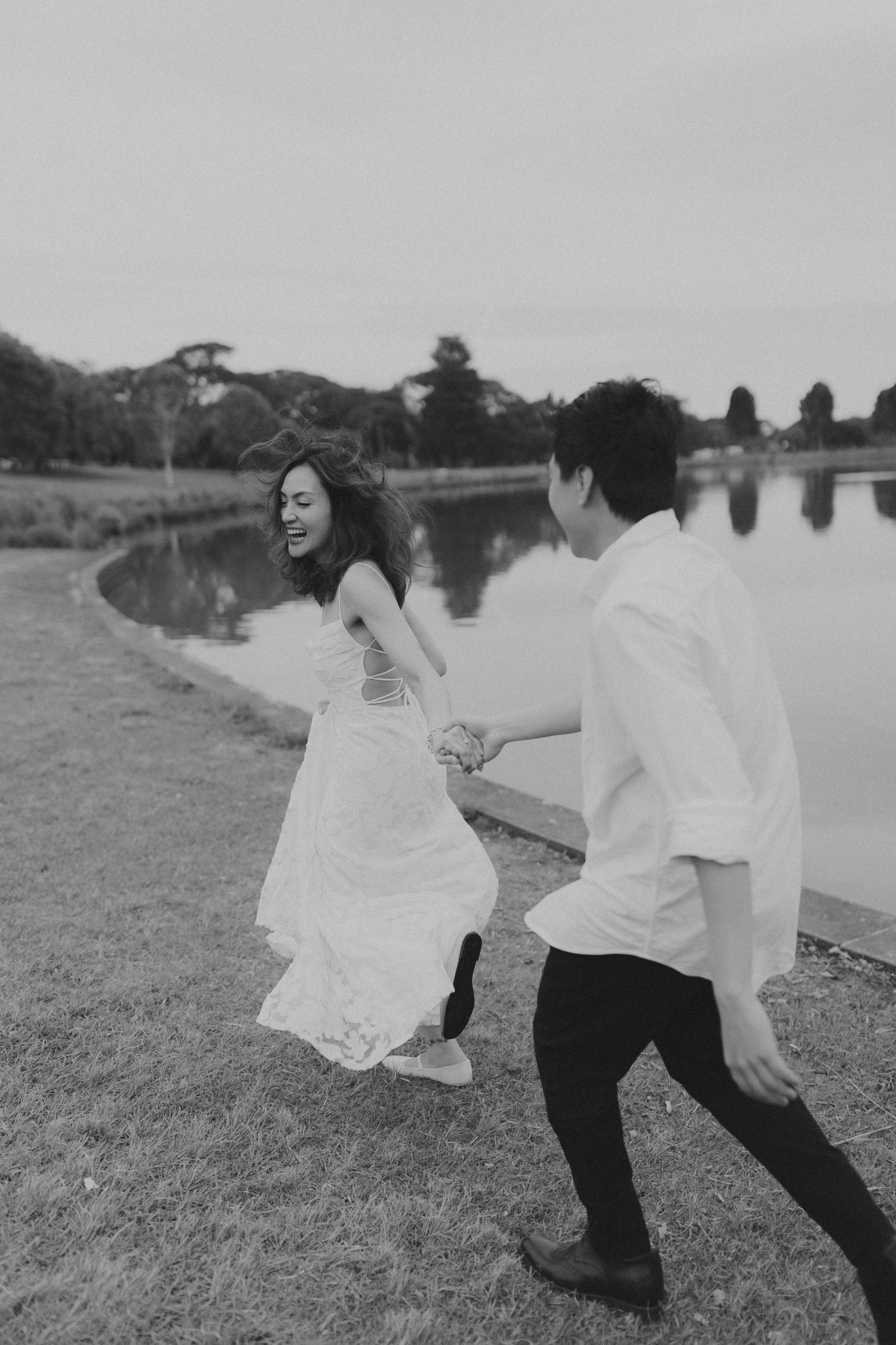 A sequence of black and white photos showing a couple dancing and twirling in a field.