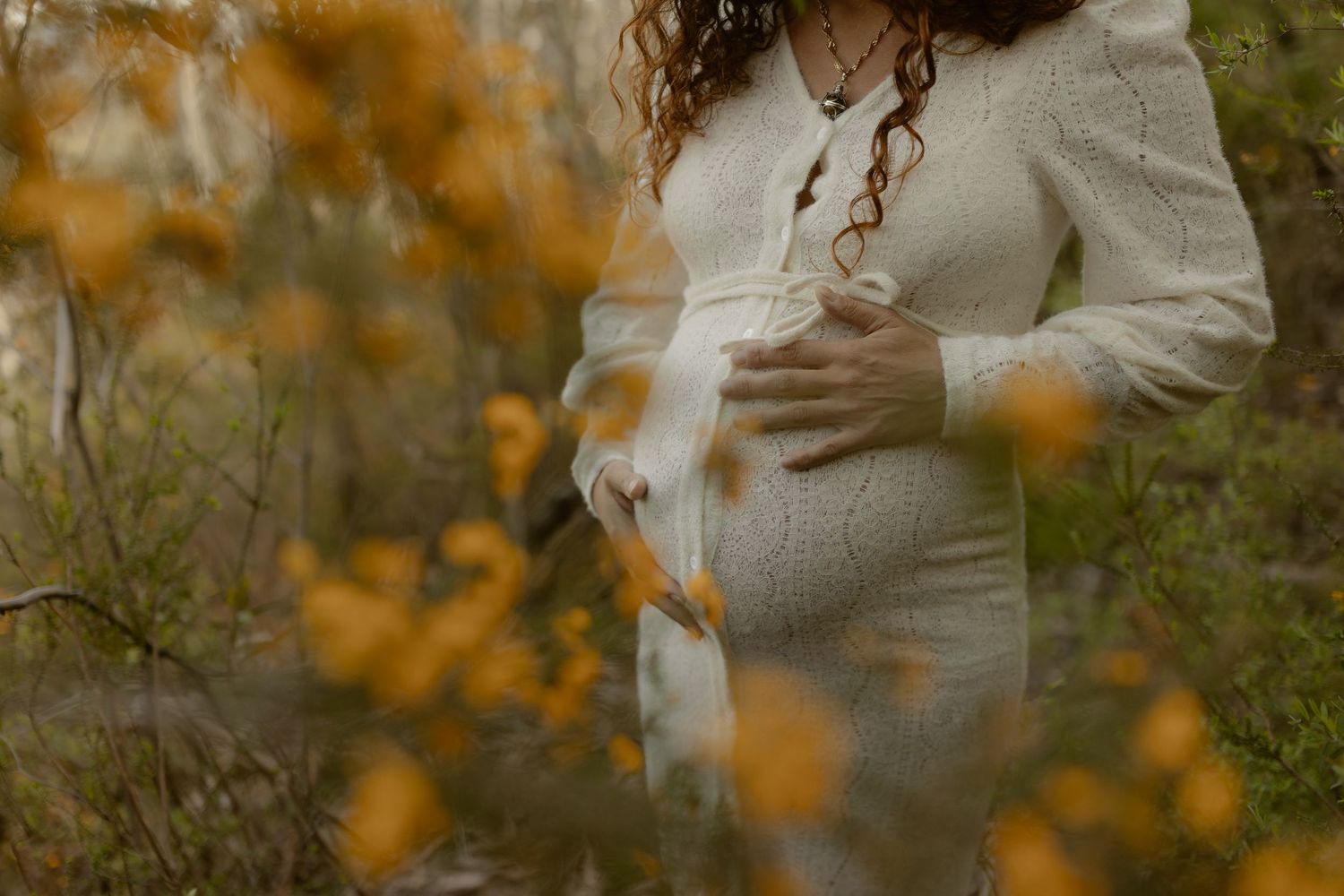 A tender moment captured between a couple in warm autumn lighting surrounded by golden leaves.