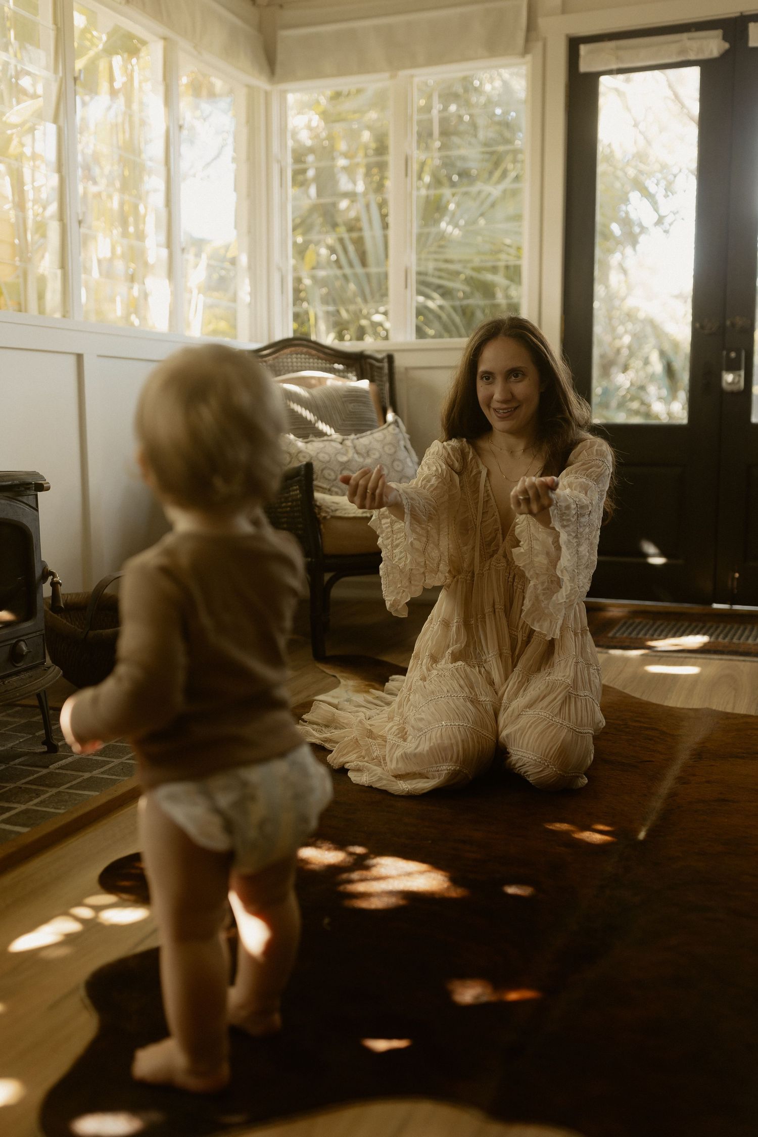 Playful movement sequence in a bright sunlit room with hardwood floors.