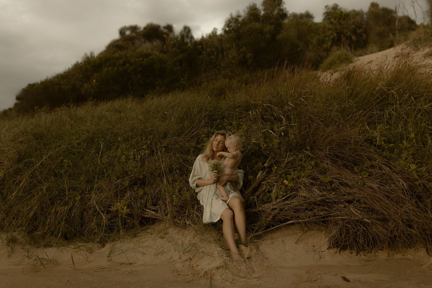 A series of sepia-toned photographs showing people enjoying a day at the beach and dunes in vintage summer attire.