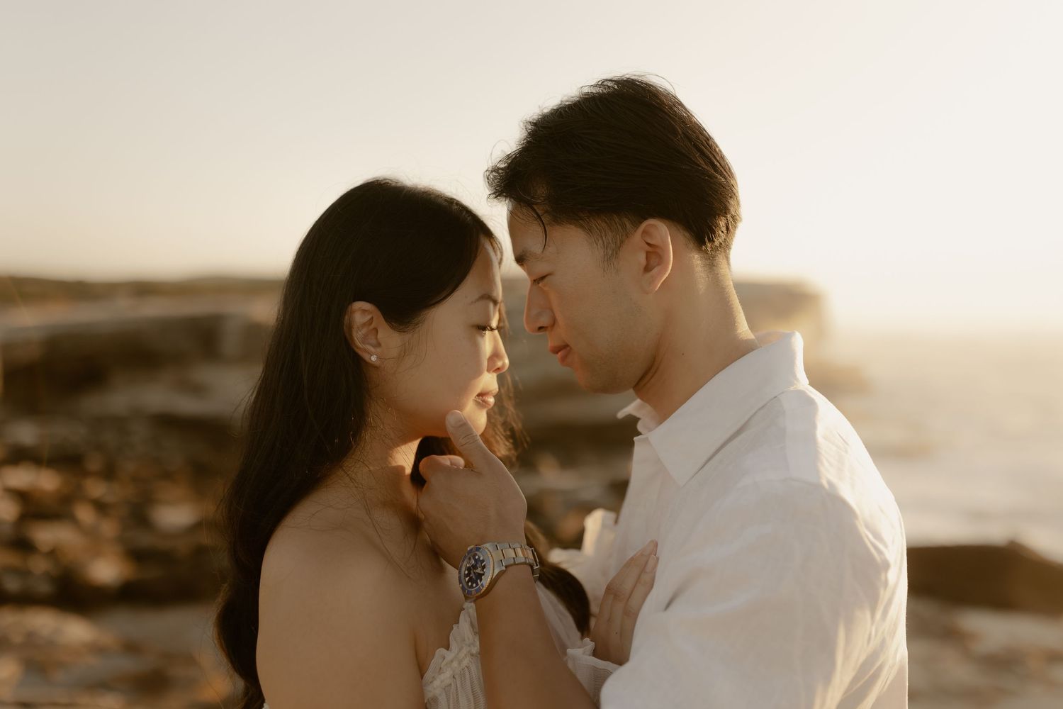 Romantic couple embraces on beach during golden hour sunset in series of intimate poses.