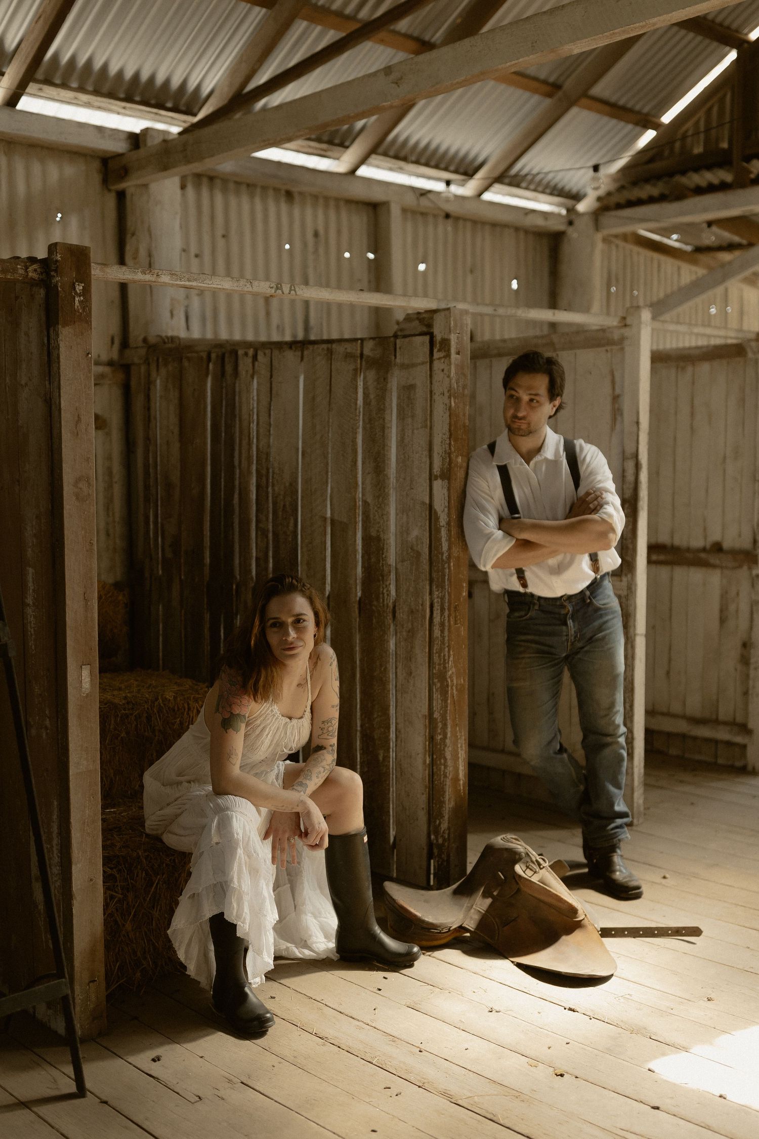 Artistic sequence inside a rustic barn with dramatic lighting and wooden details.