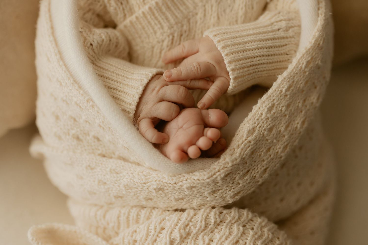 A collage of hands close up wearing cozy knit sweaters in warm neutral tones.