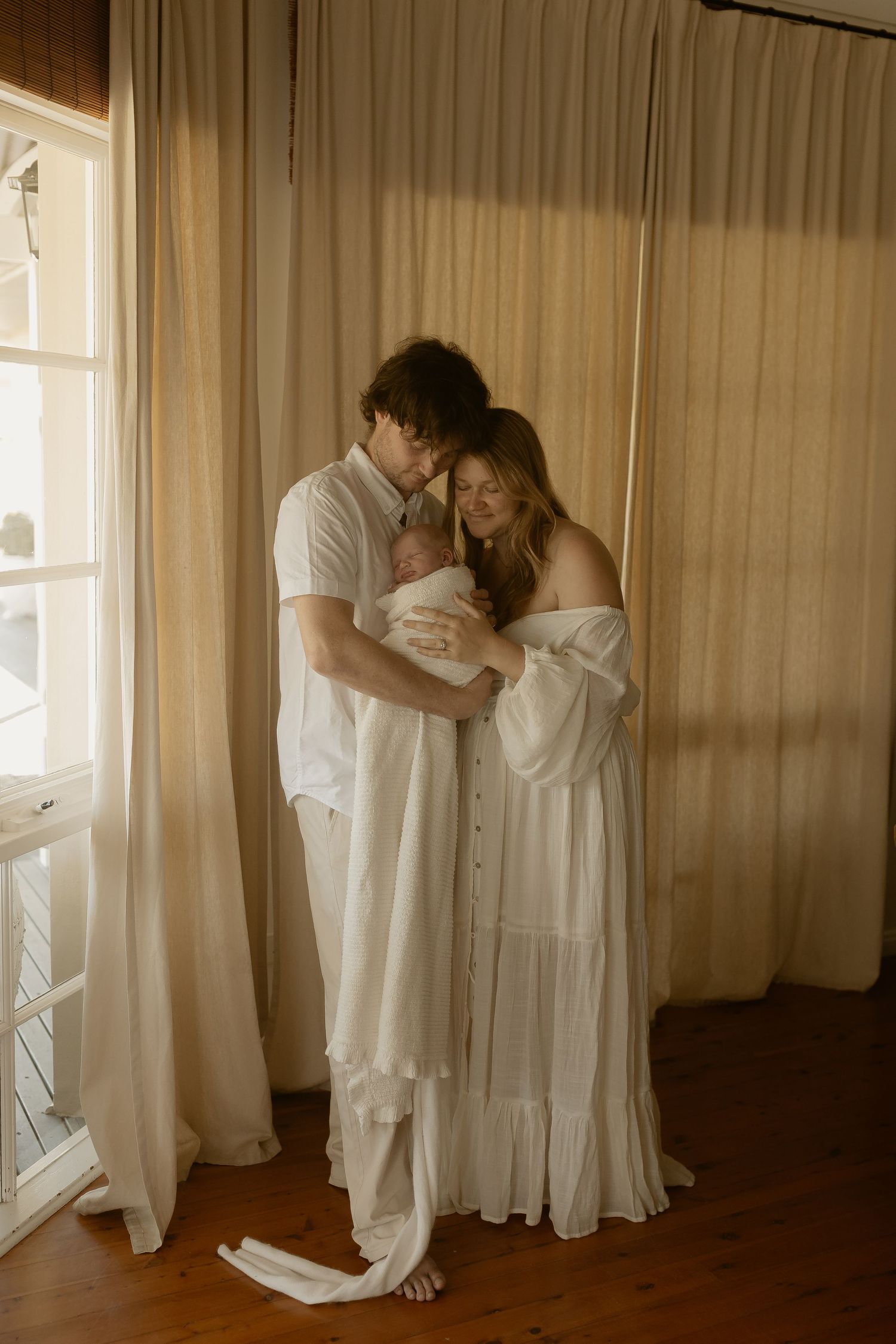 A romantic sequence of four sepia-toned photographs showing an intimate dance between two people in white clothing.