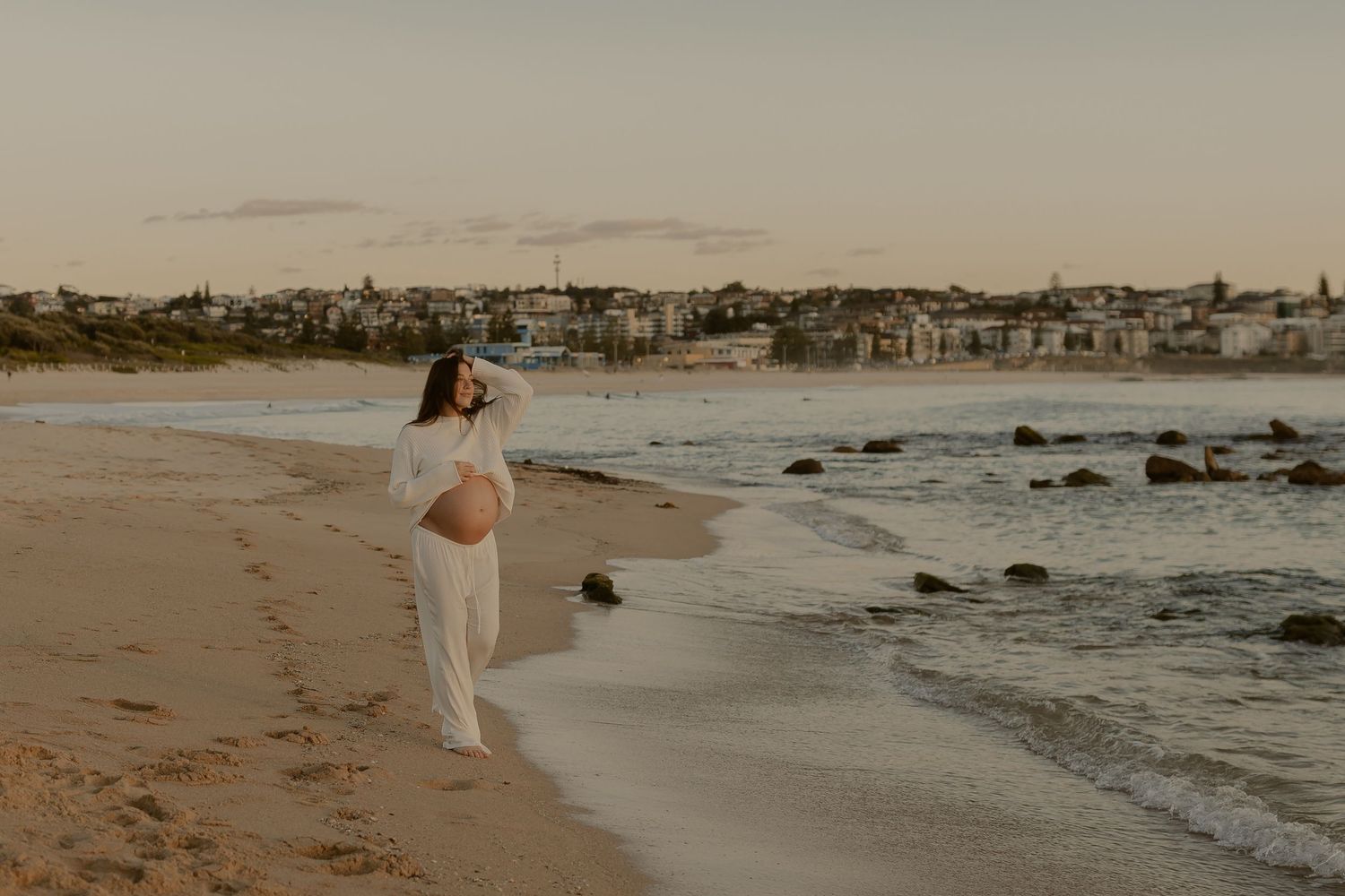 A collection of coastal beach scenes with waves, rocks and shoreline during golden hour.