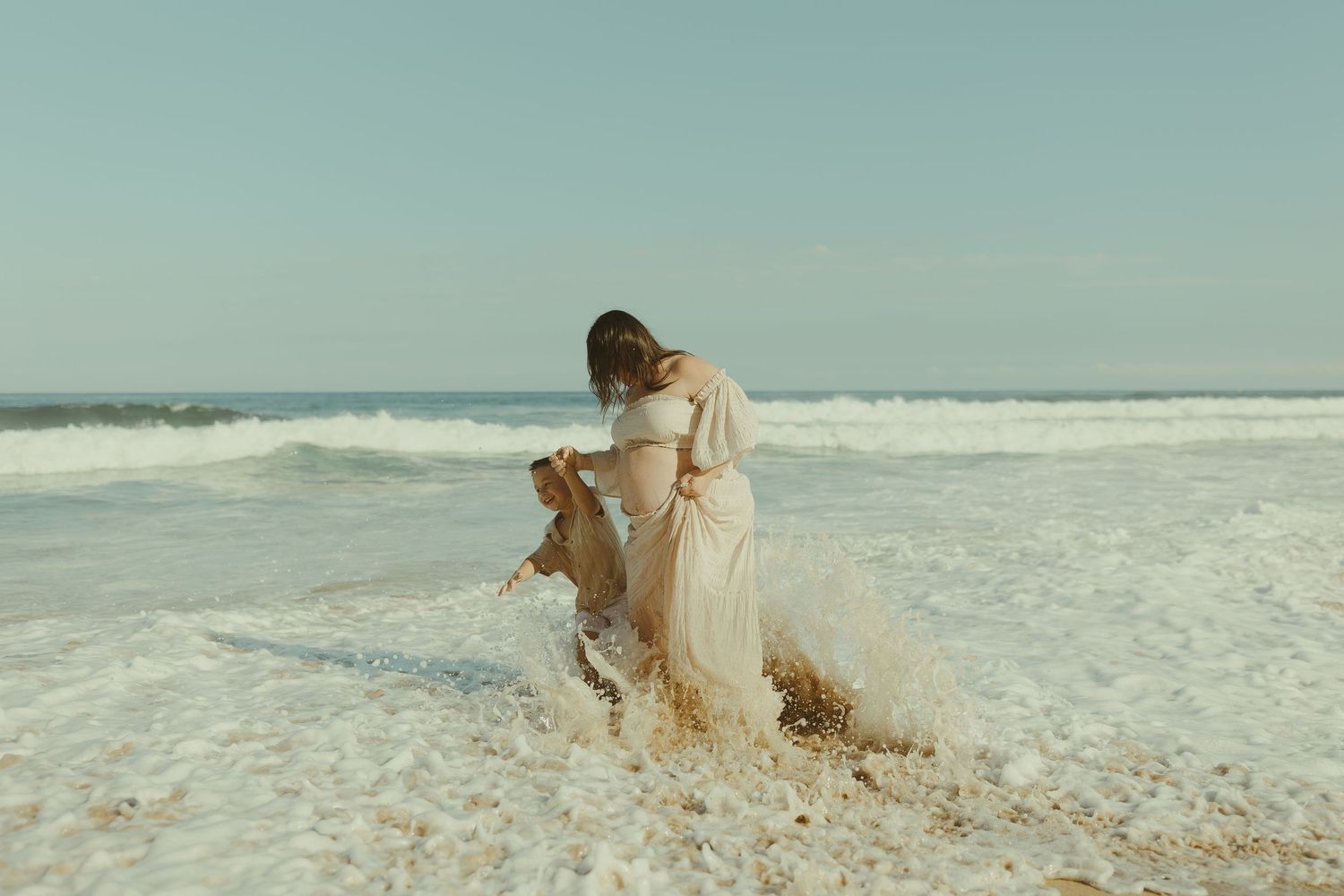 A series of people enjoying a peaceful day at the beach with waves crashing in the background.