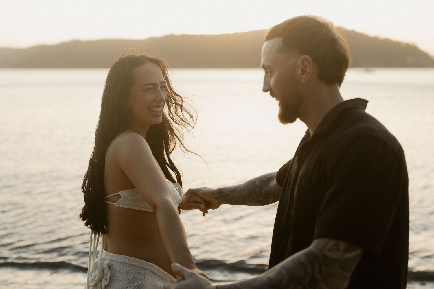 A series of photos showing a couple having fun along a beach shore at sunset in warm glowing light.
