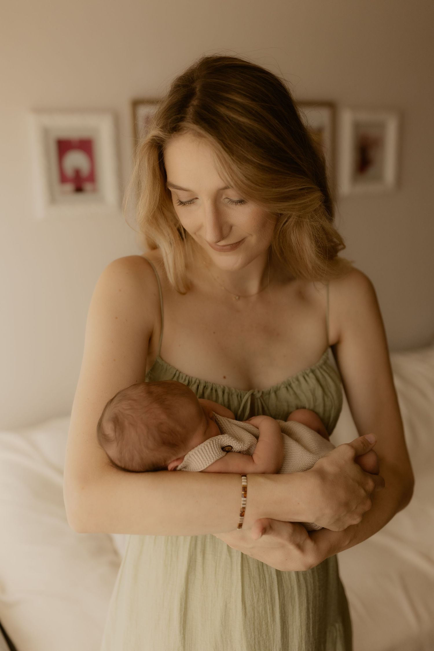 A series of intimate photos showing tender moments with a newborn baby in a bedroom setting.