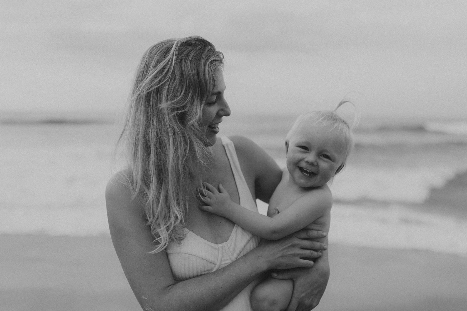 Mother and baby sharing joyful moments together on a bright sunny day.