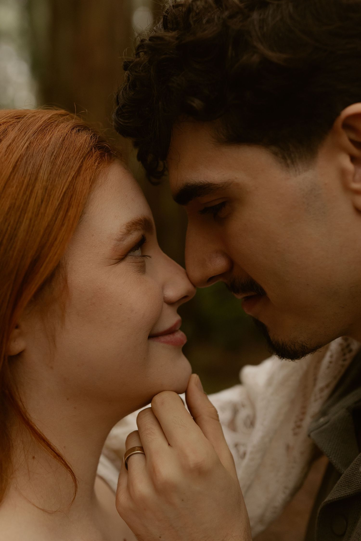 A romantic sequence showing a couple in an intimate close-up moment with warm lighting and soft focus.