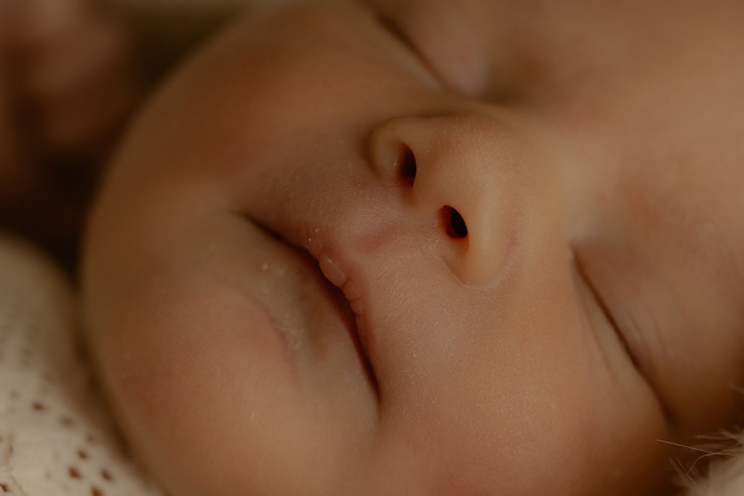 Close-up sequence showing a baby's peaceful sleeping face from different angles.
