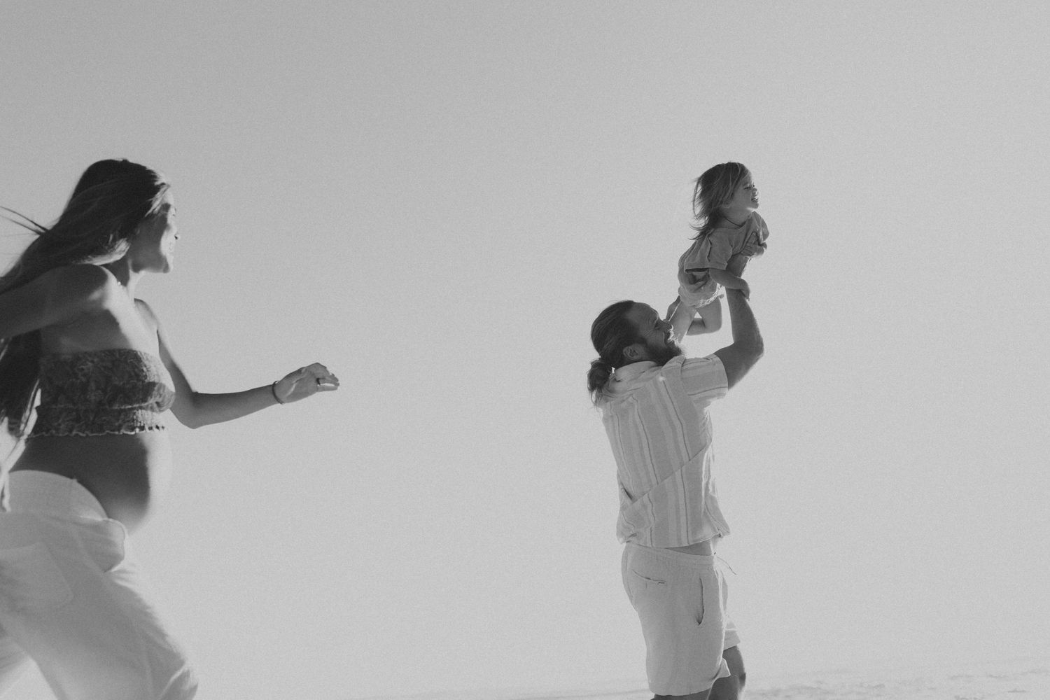 Silhouettes dance and move expressively against a light gray background.