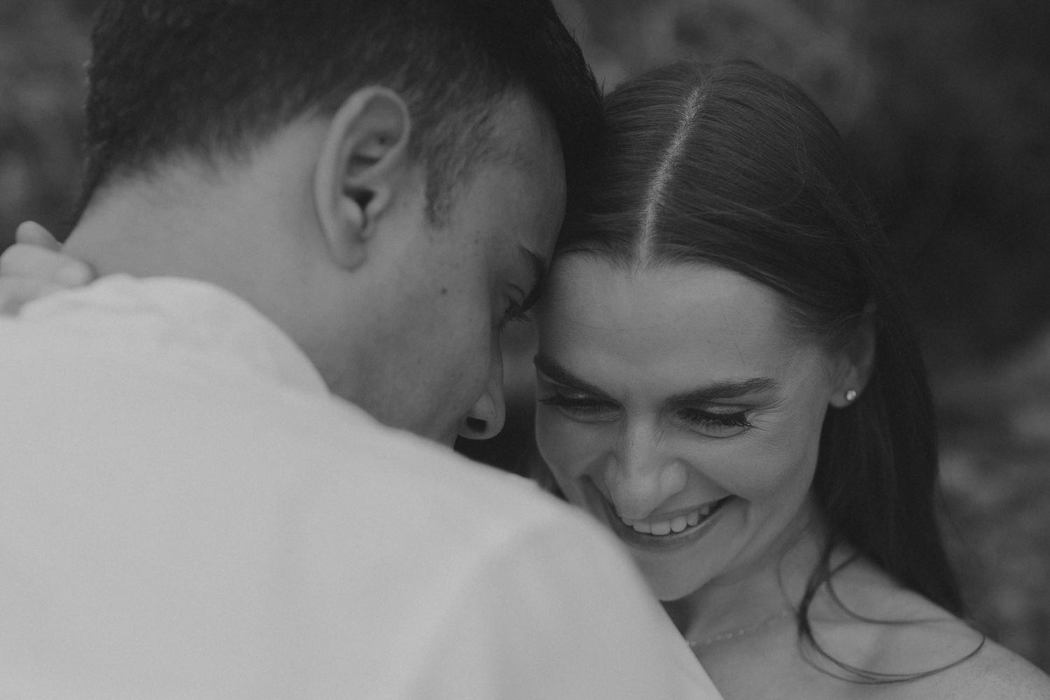 A black and white photo series shows intimate moments between a couple sharing tender kisses and embraces.