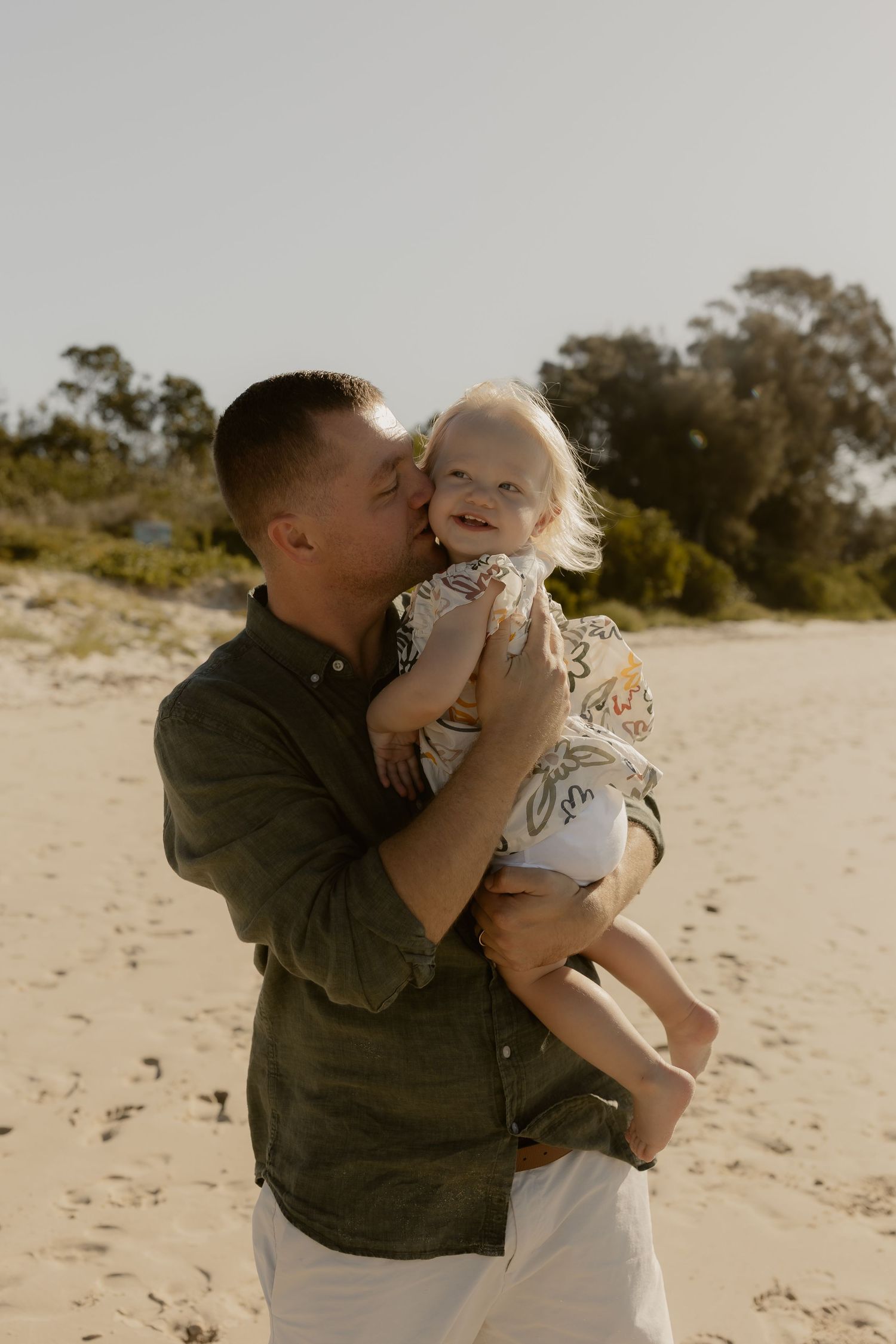 Sweet moment shared between parent and child on a sunny beach.