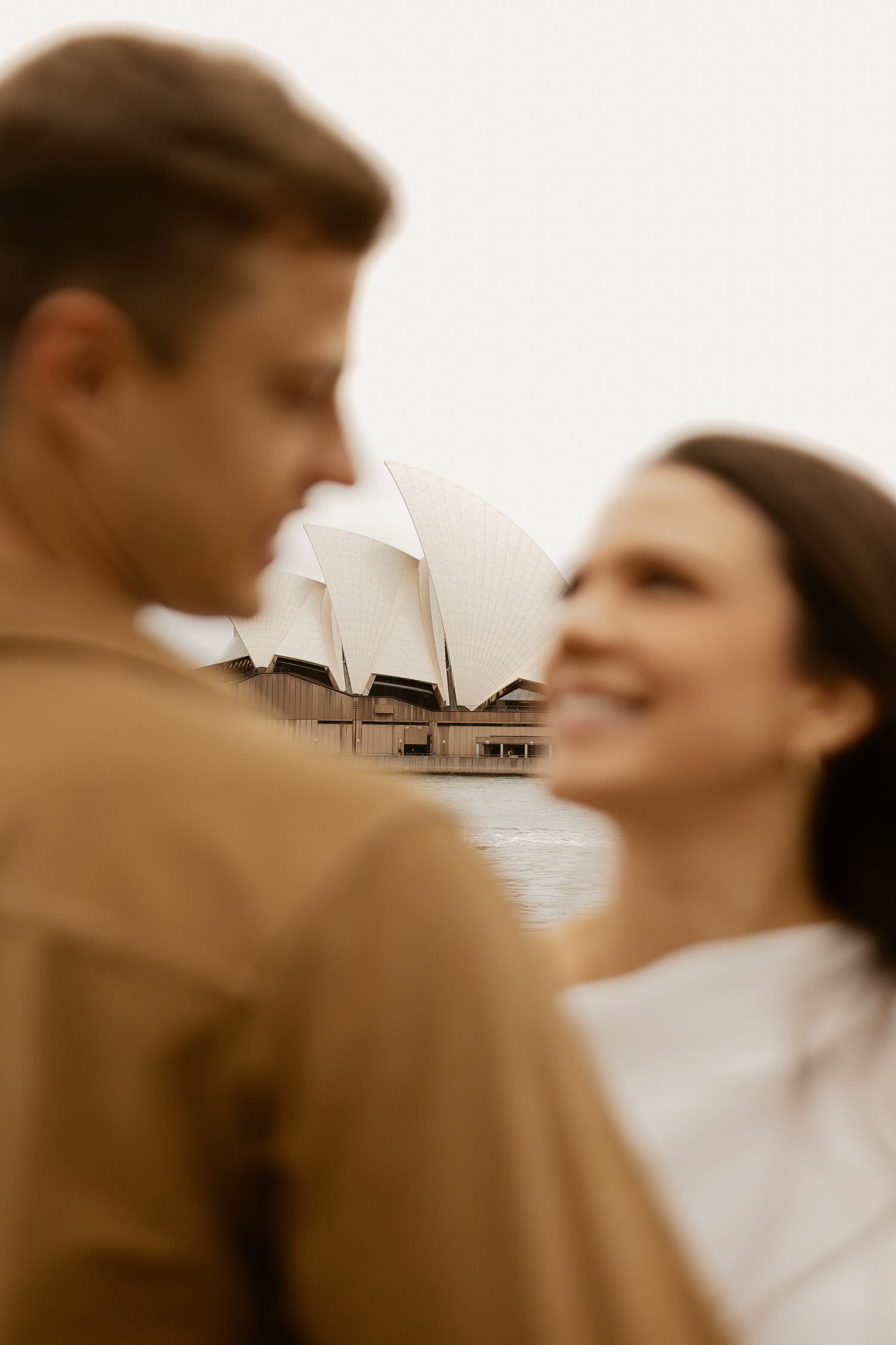 Romantic silhouette with Sydney Opera House visible in background.