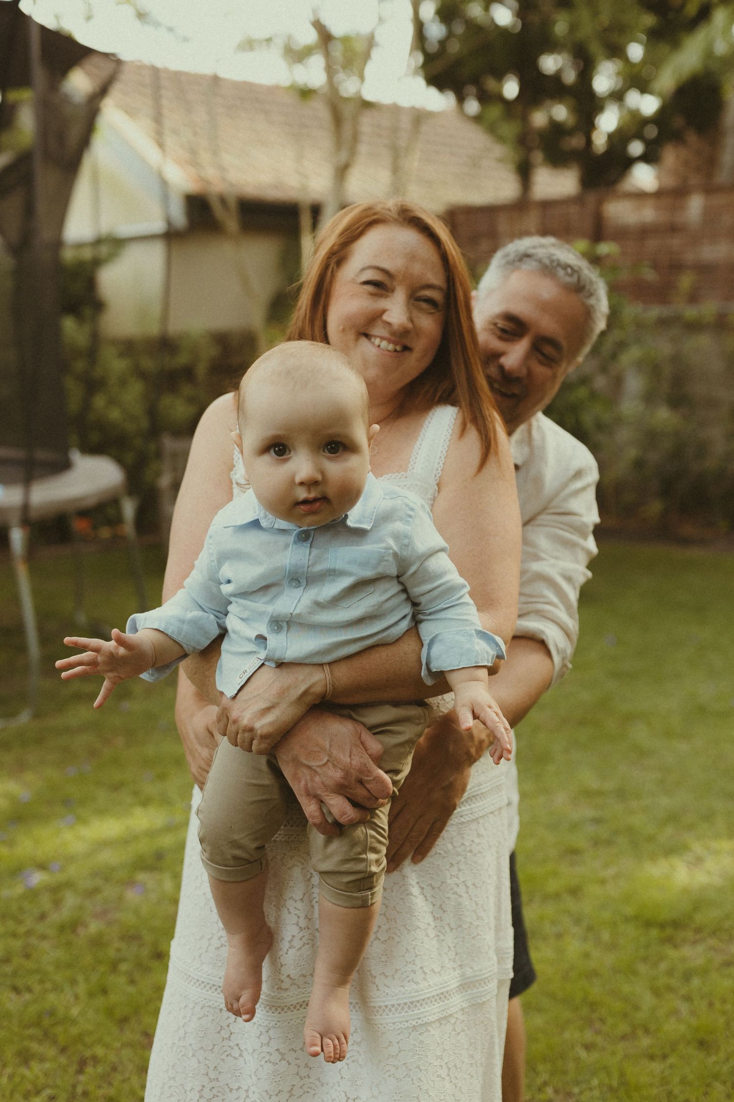 Family moments captured in a sunlit backyard setting.