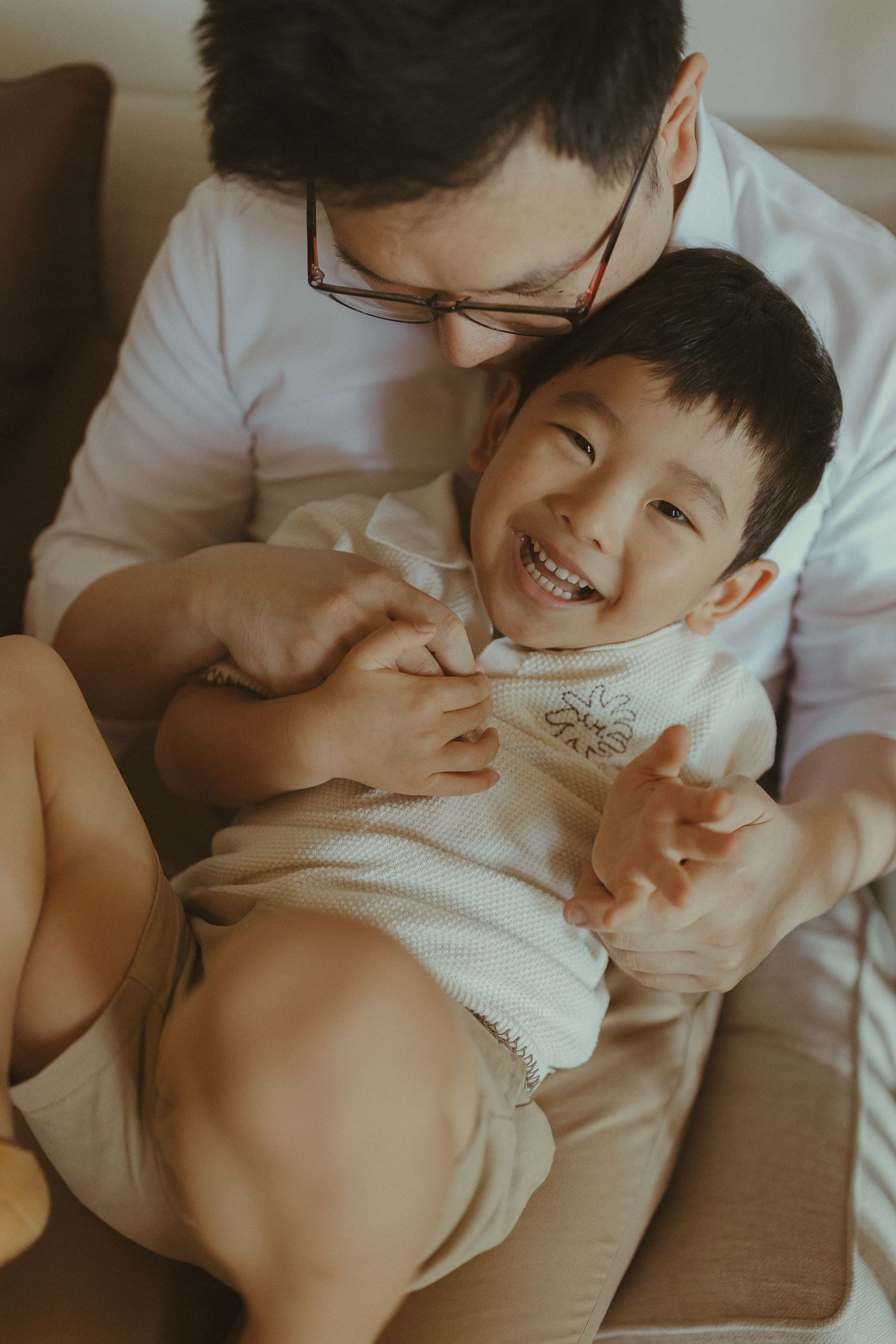A heartwarming family moment captured while relaxing together indoors.