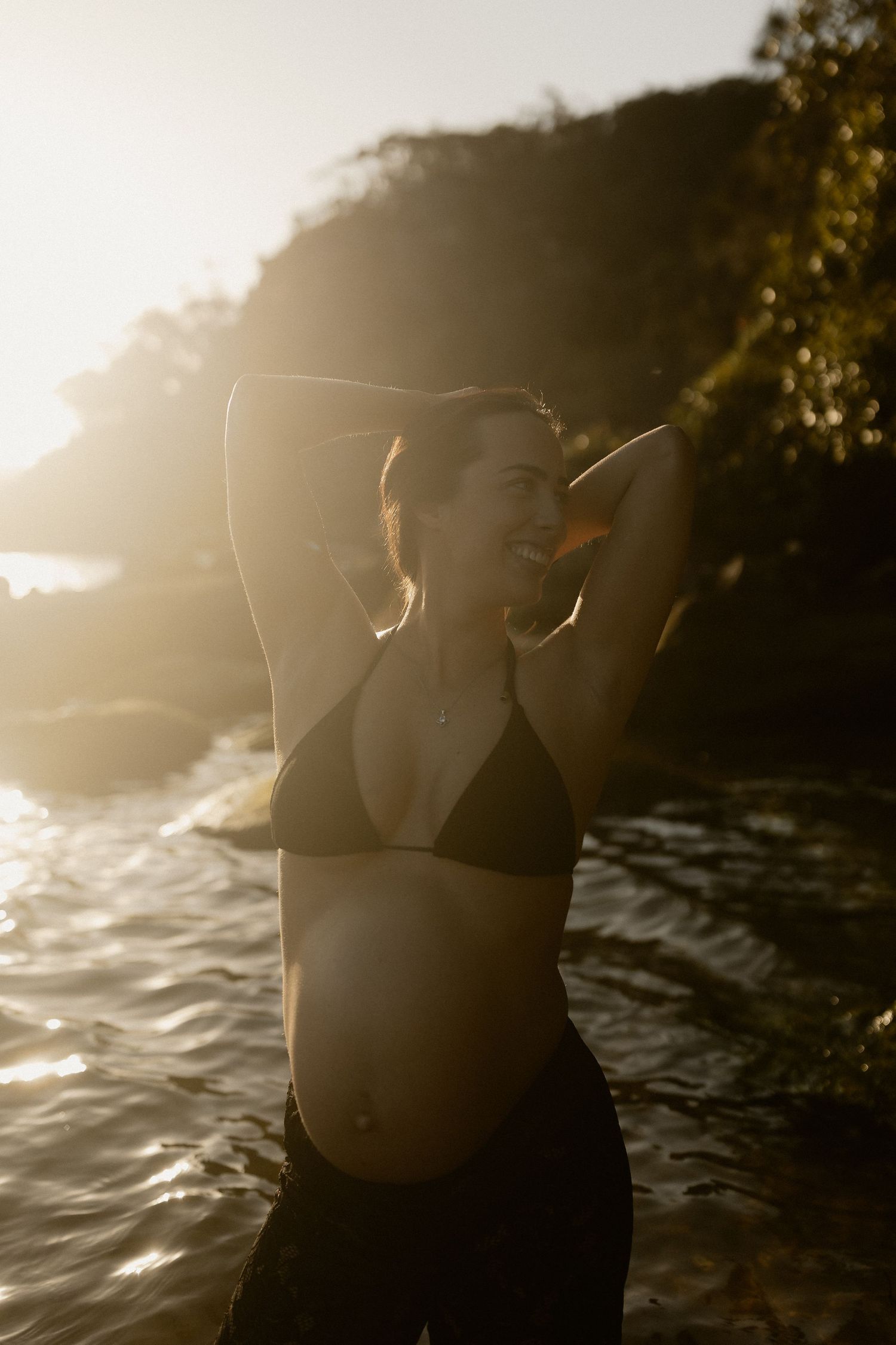 A series of dreamy golden-hour photos showing a silhouetted figure standing in front of rippling water and sunlight.