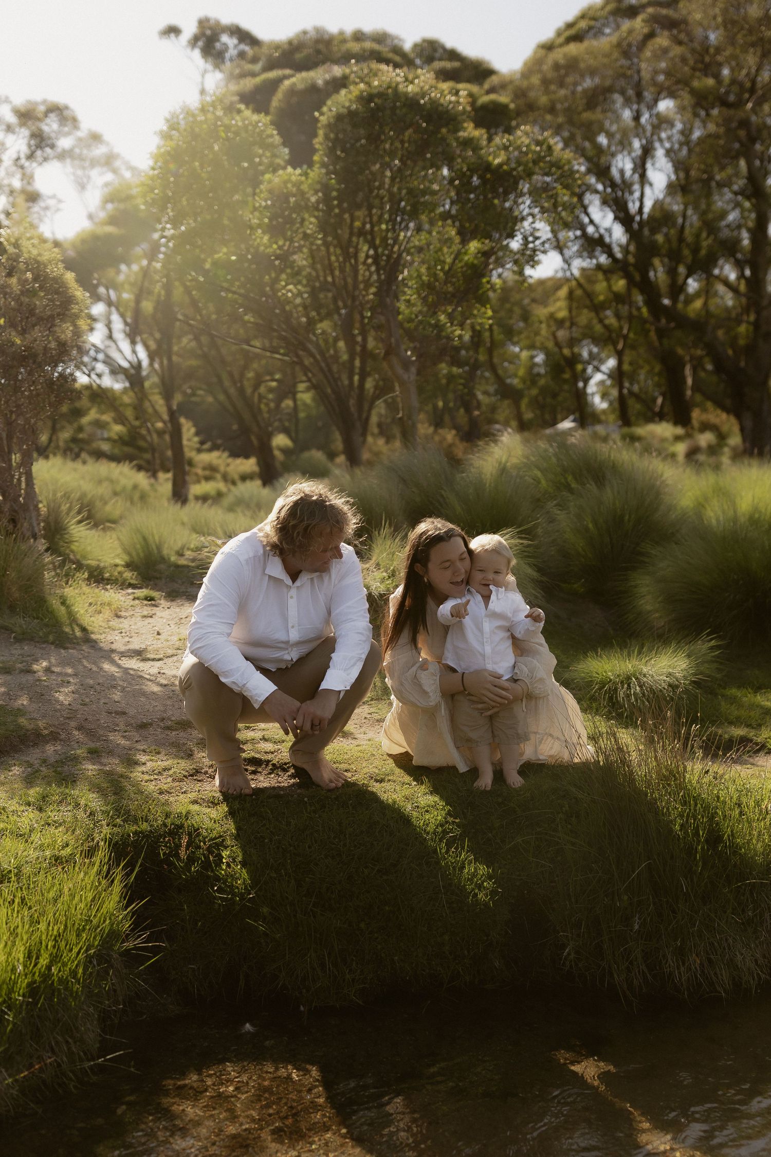 Candid outdoor family scene with natural lighting and Australian bushland setting.