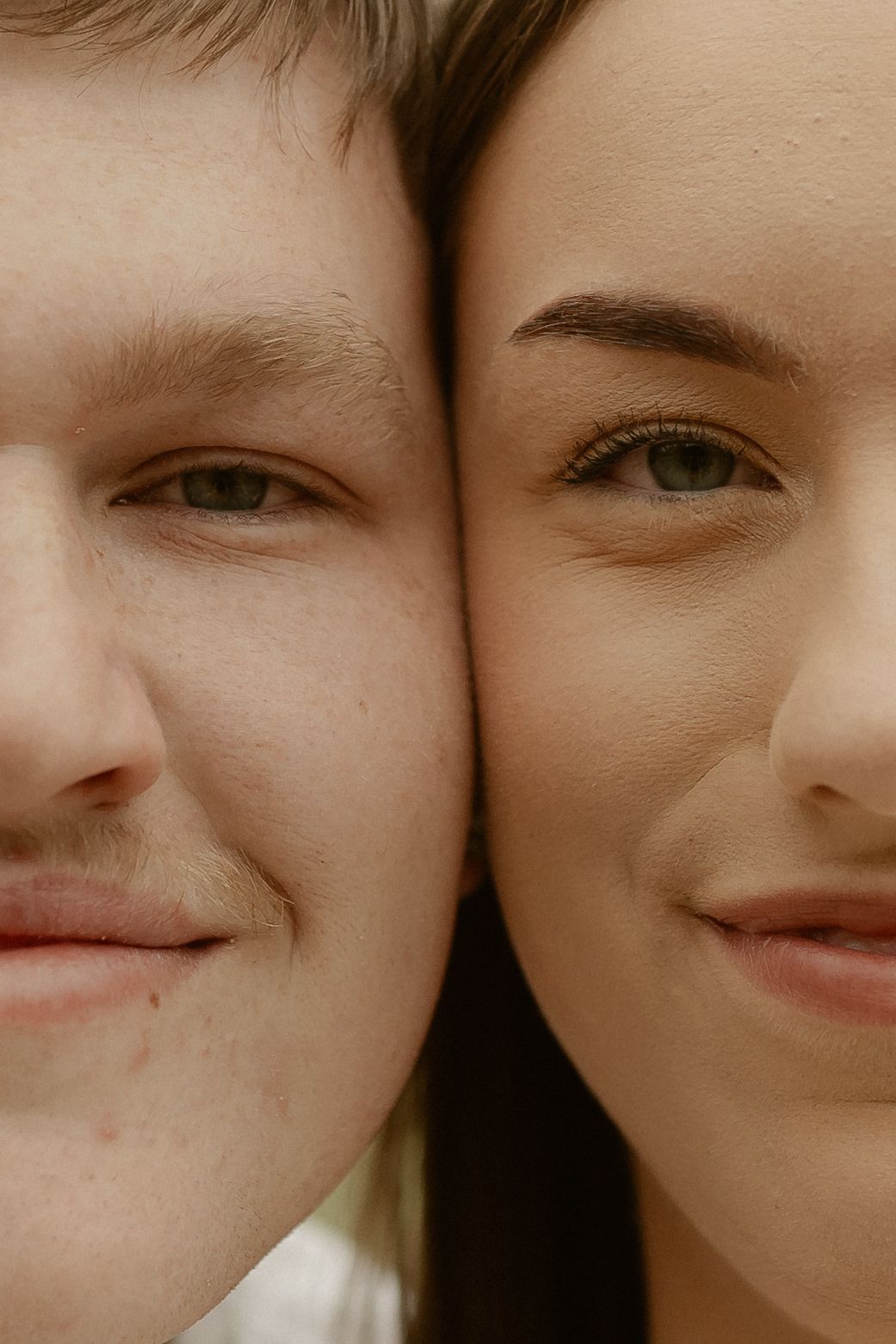 A close-up photo shows two people smiling side by side, with the image cropped to focus on their eyes and mouths.