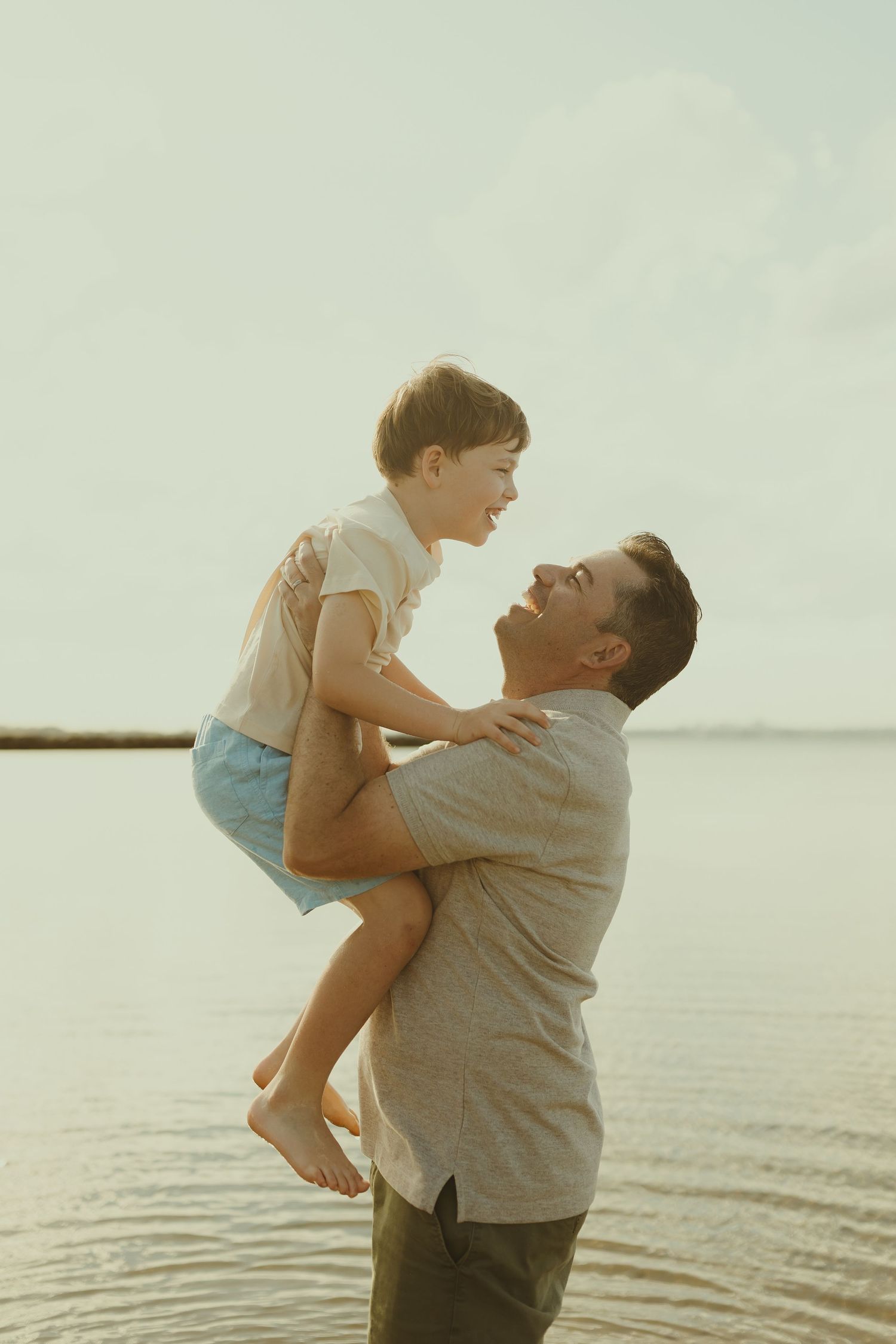 A heartwarming scene of bonding and play by the waterfront during golden hour.