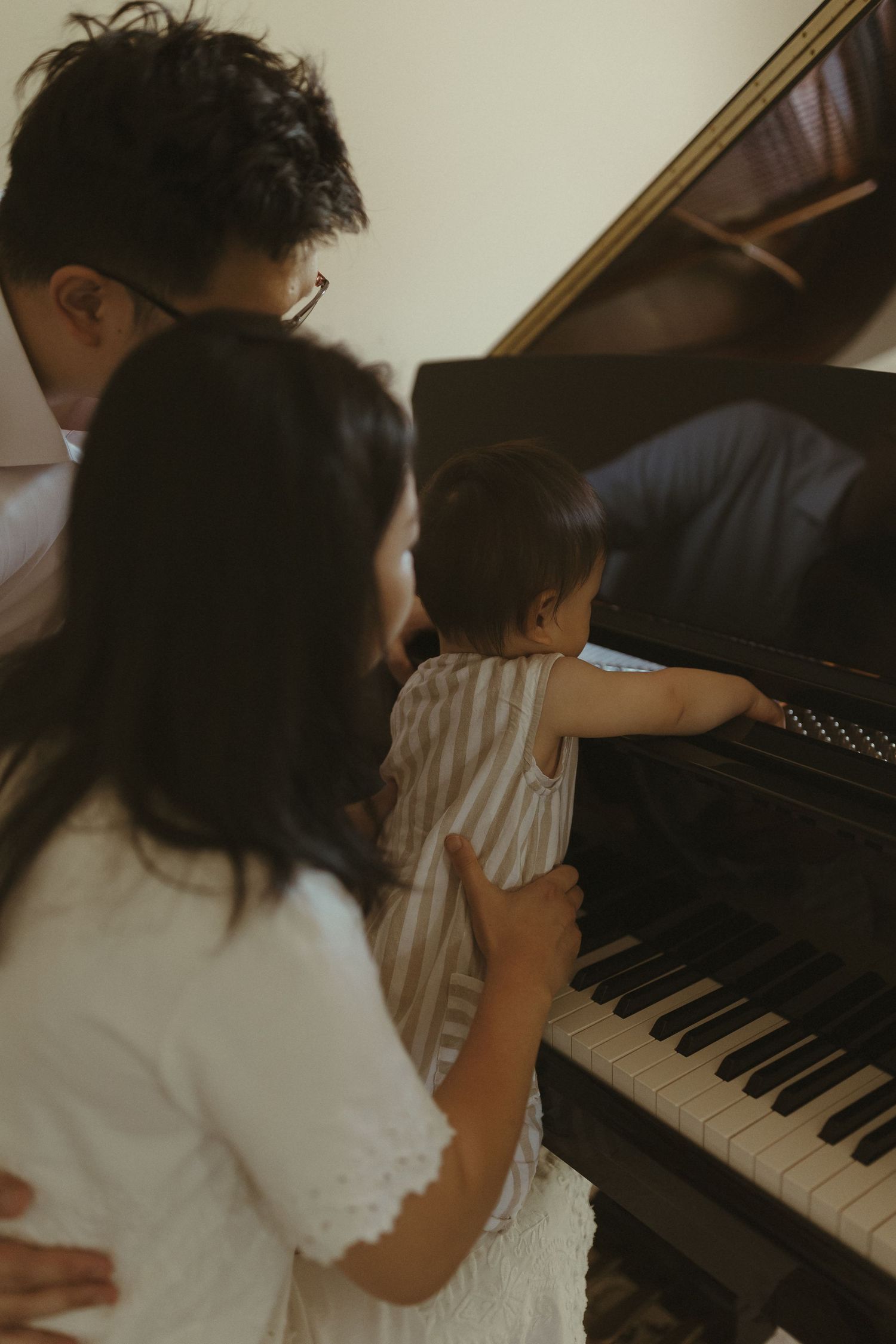 People gathered around a piano sharing an intimate musical moment together.