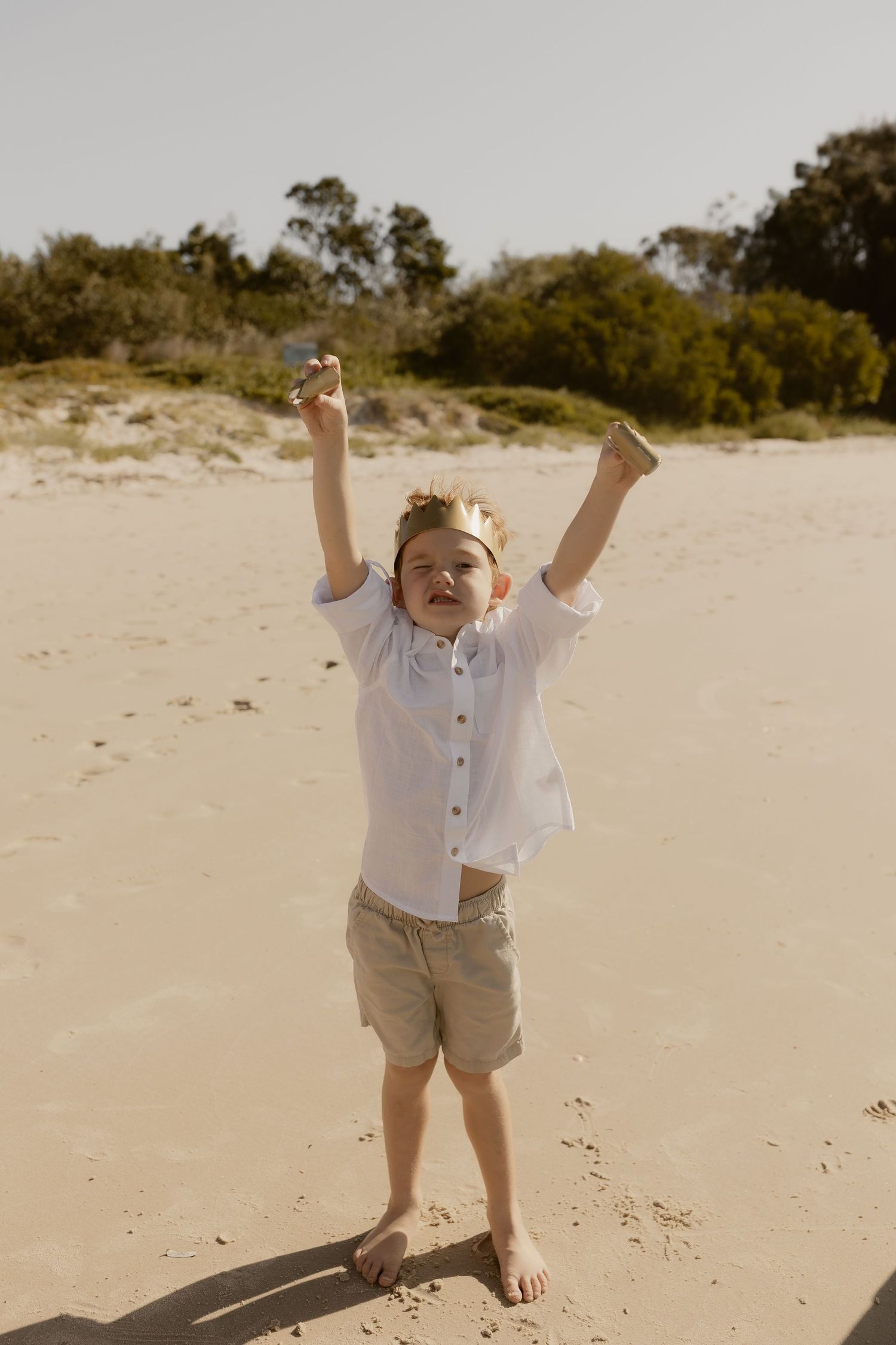 A series of joyful moments captured on a sandy beach with trees in the background.
