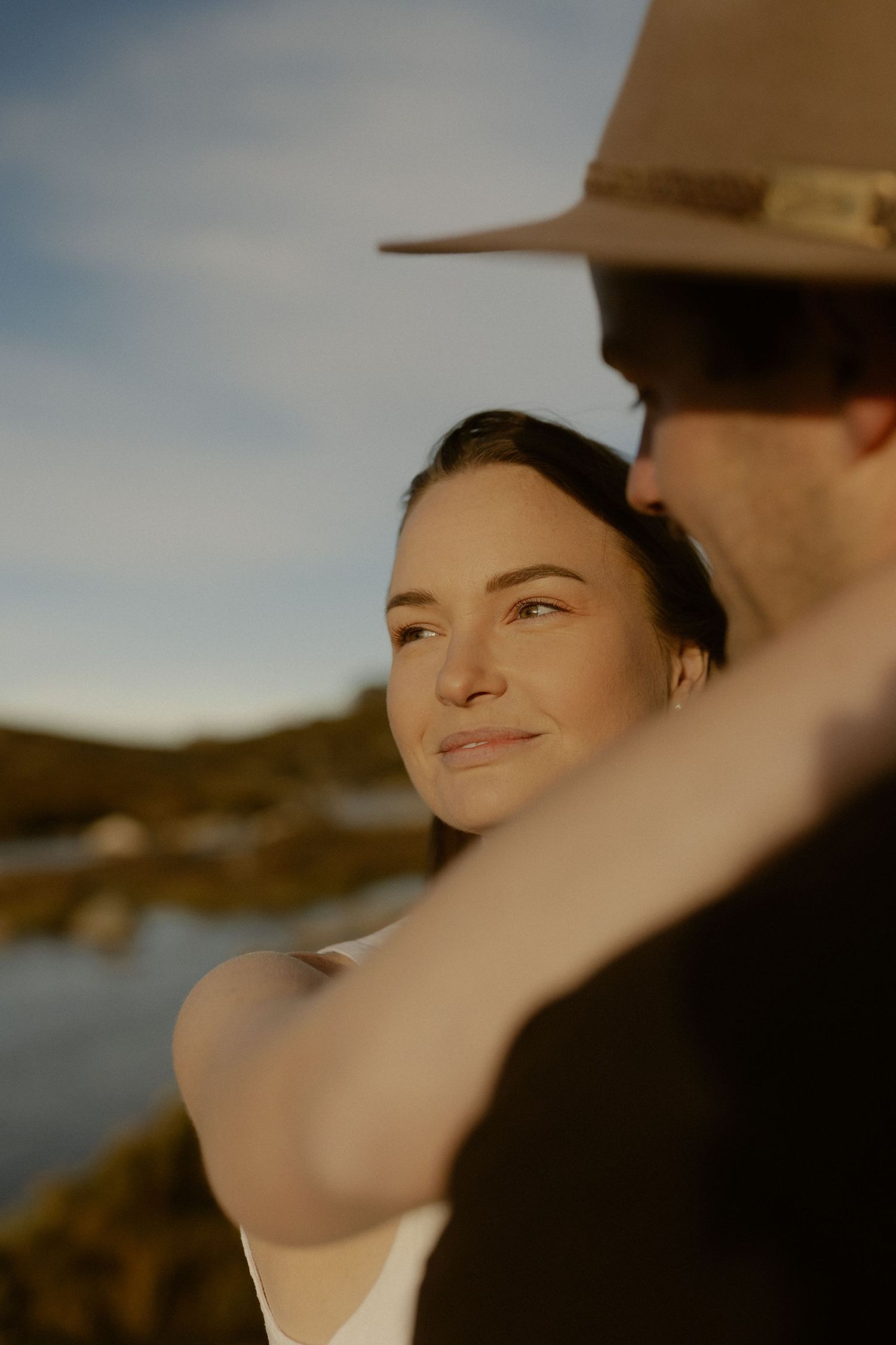 A dreamy portrait sequence shows someone in a hat gazing upward with soft lighting and a blurred outdoor background.