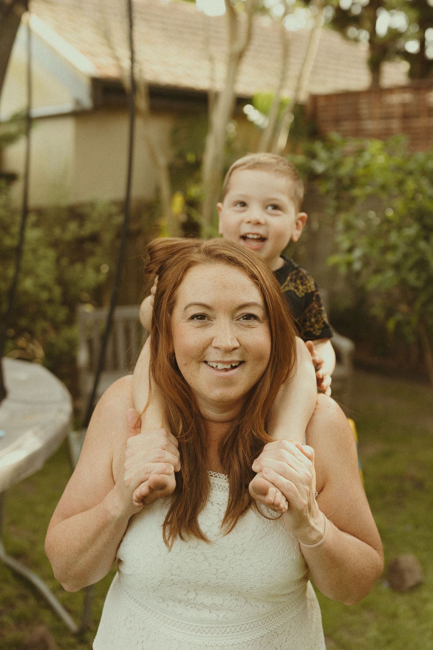 Cheerful outdoor portraits showing thumbs up gestures in a backyard setting.