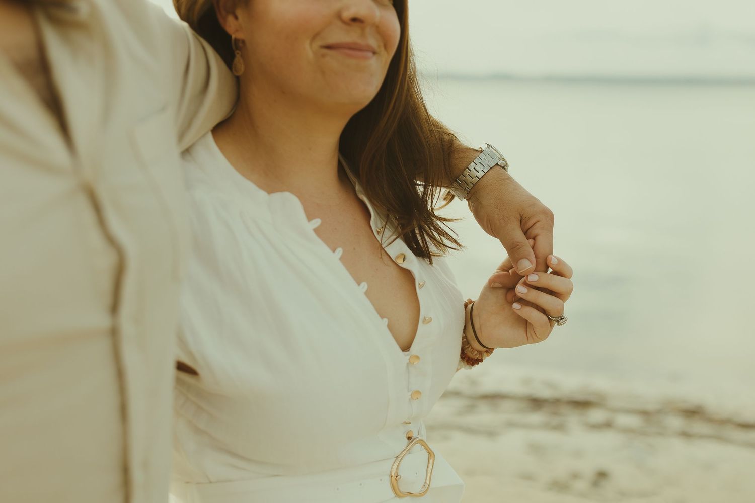 Close-up shot of a couple sharing intimate moments on a beach.