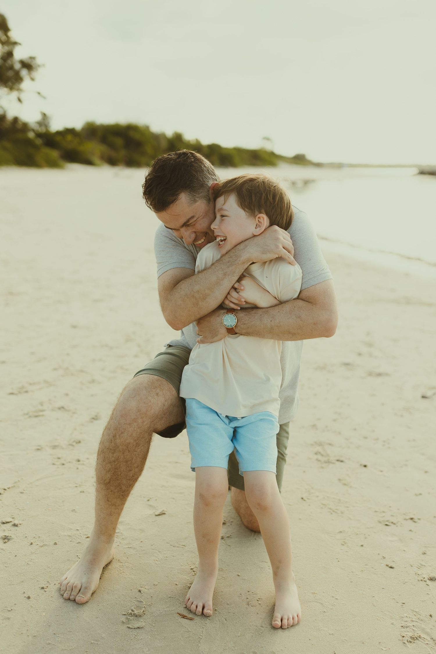Playful father and child moments captured in sequence on a sunny beach.