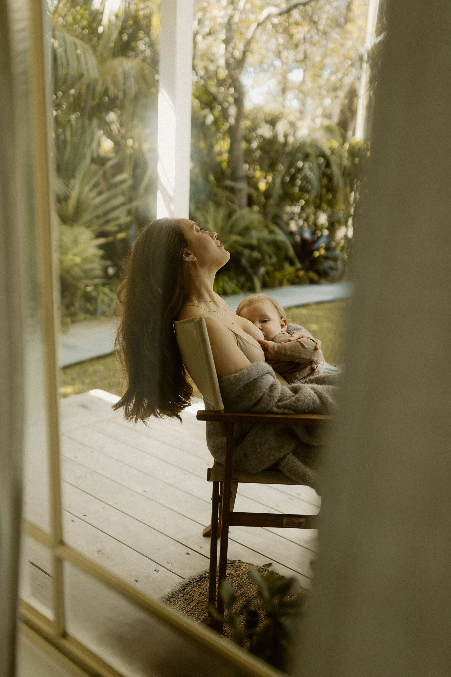 Serene moments captured on wooden porch surrounded by lush greenery.