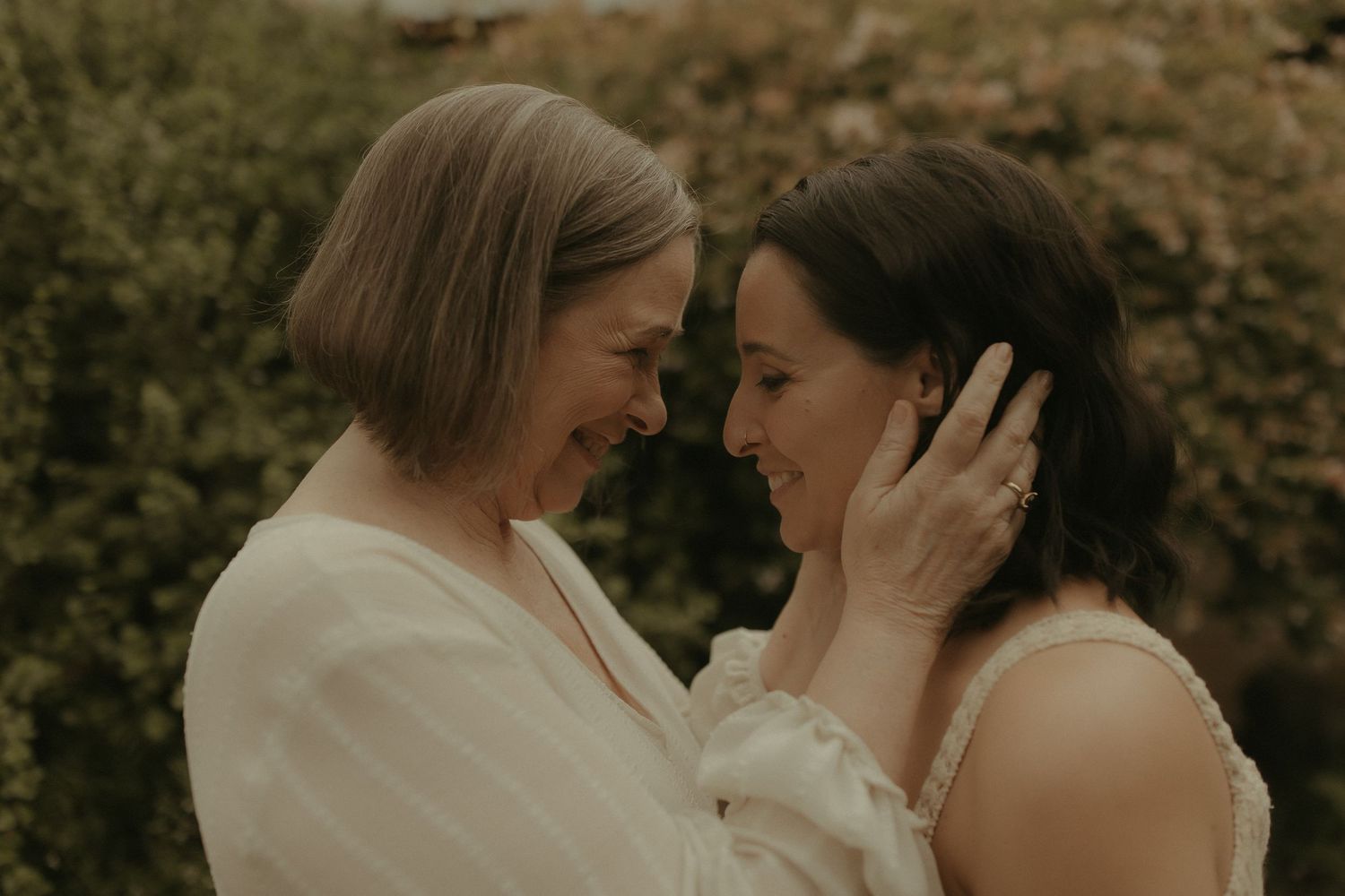 Romantic outdoor portrait session capturing gentle moments between two people in warm sunlight.
