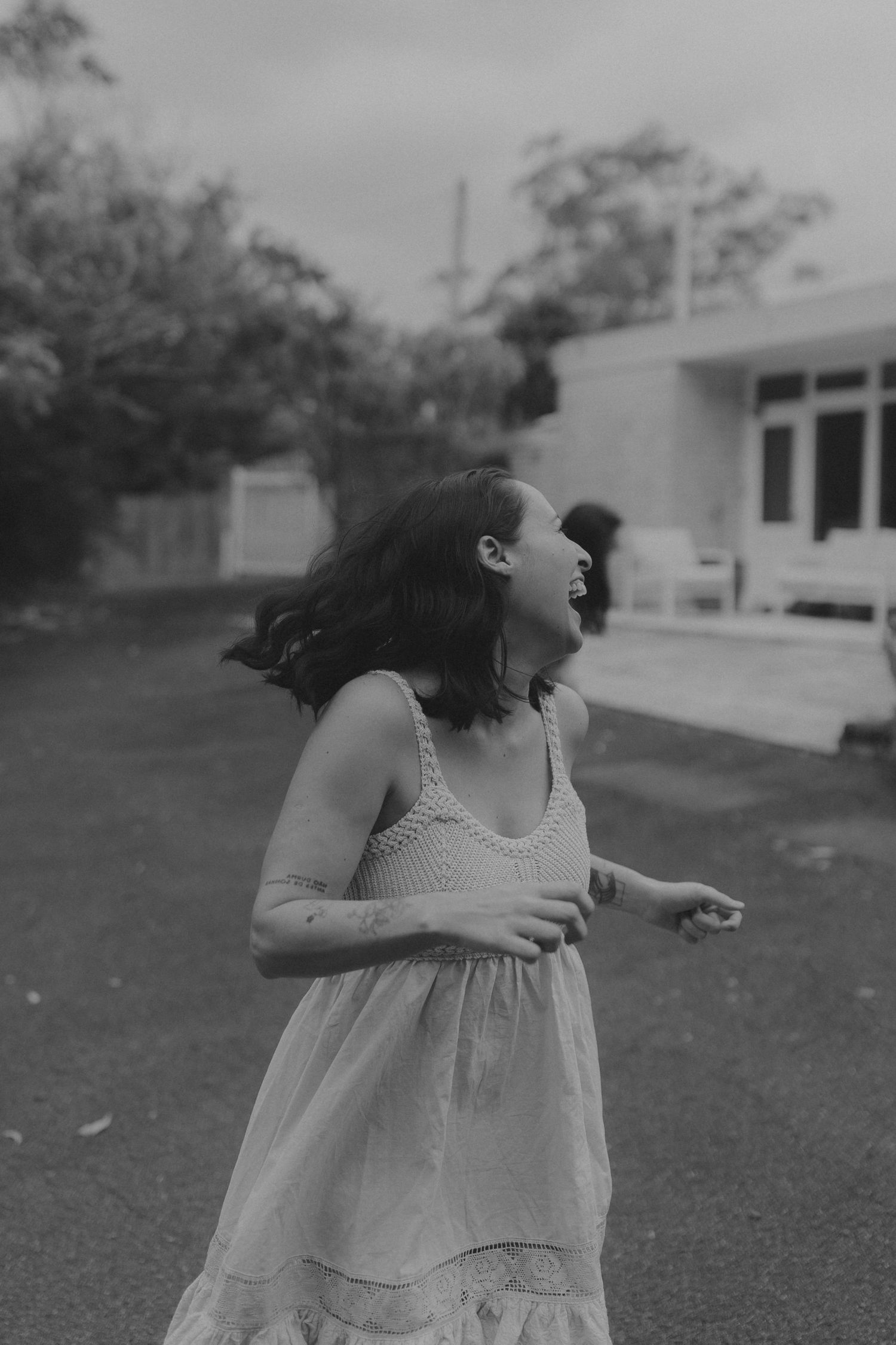 A candid black and white photo sequence showing movement and dancing outdoors.