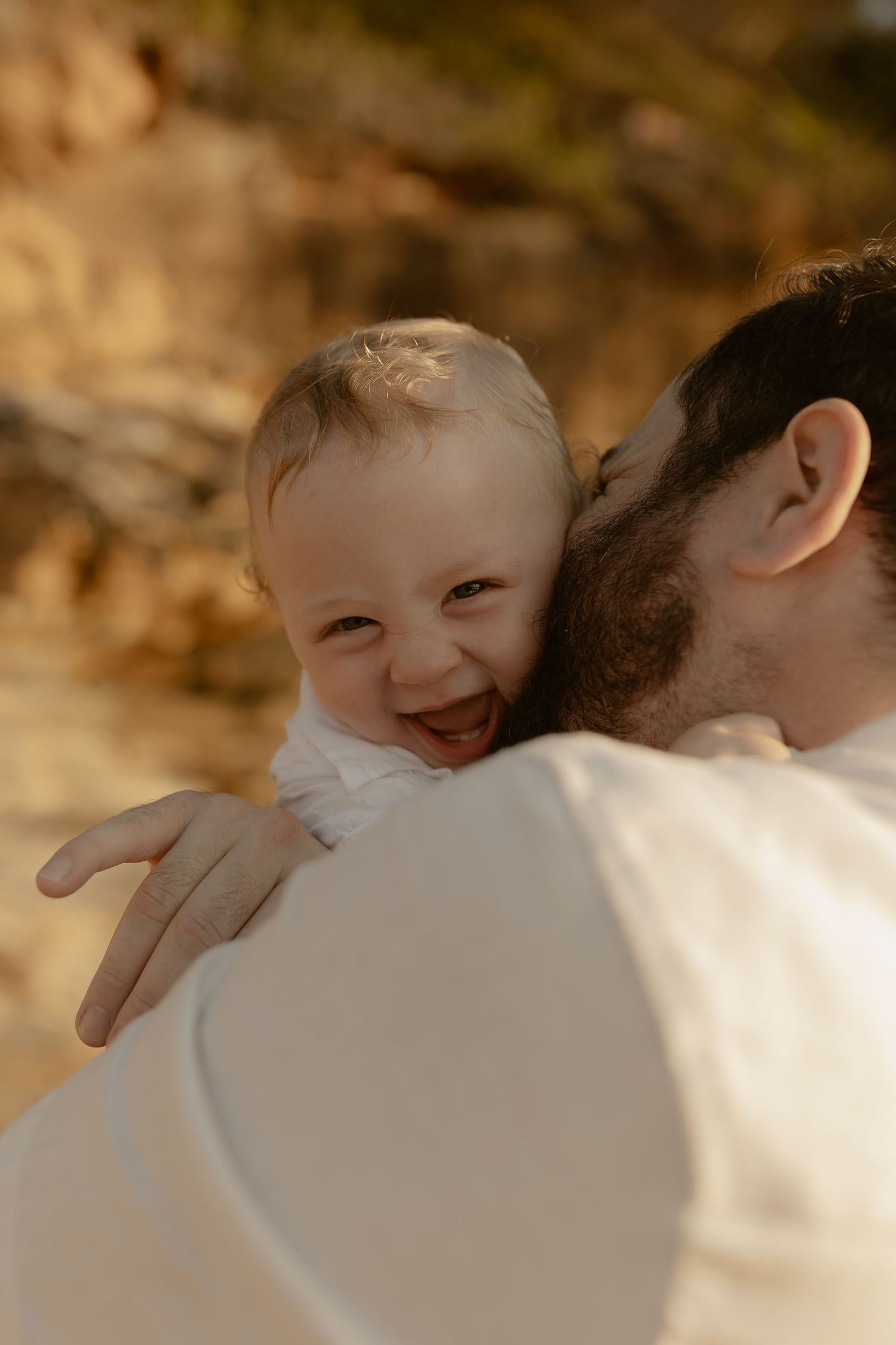 A heartwarming sequence shows a tender moment between parent and child sharing a loving embrace outdoors.