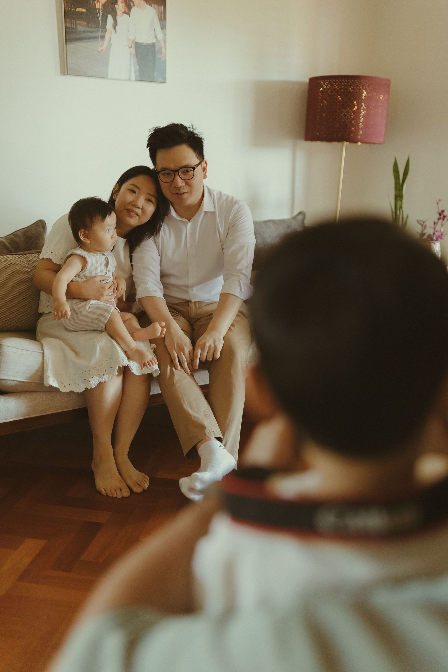Family spending quality time together on hardwood floor in a cozy living room setting.