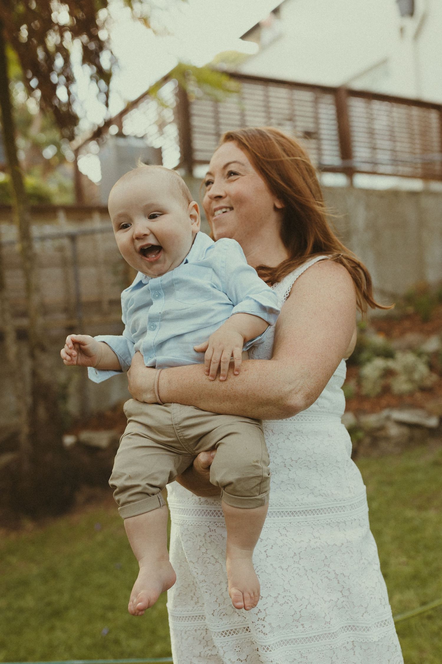 A joyful moment captured in a backyard with people in white attire.