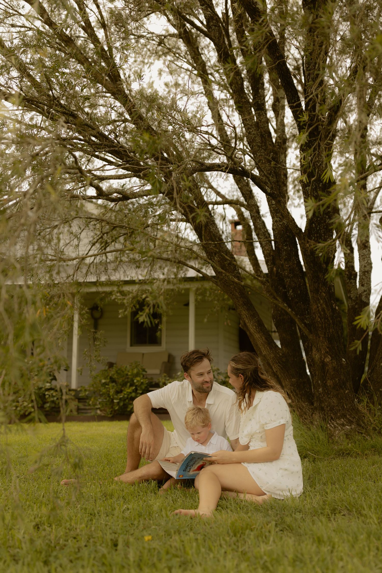 A peaceful moment shared under shady trees in a rural backyard setting.