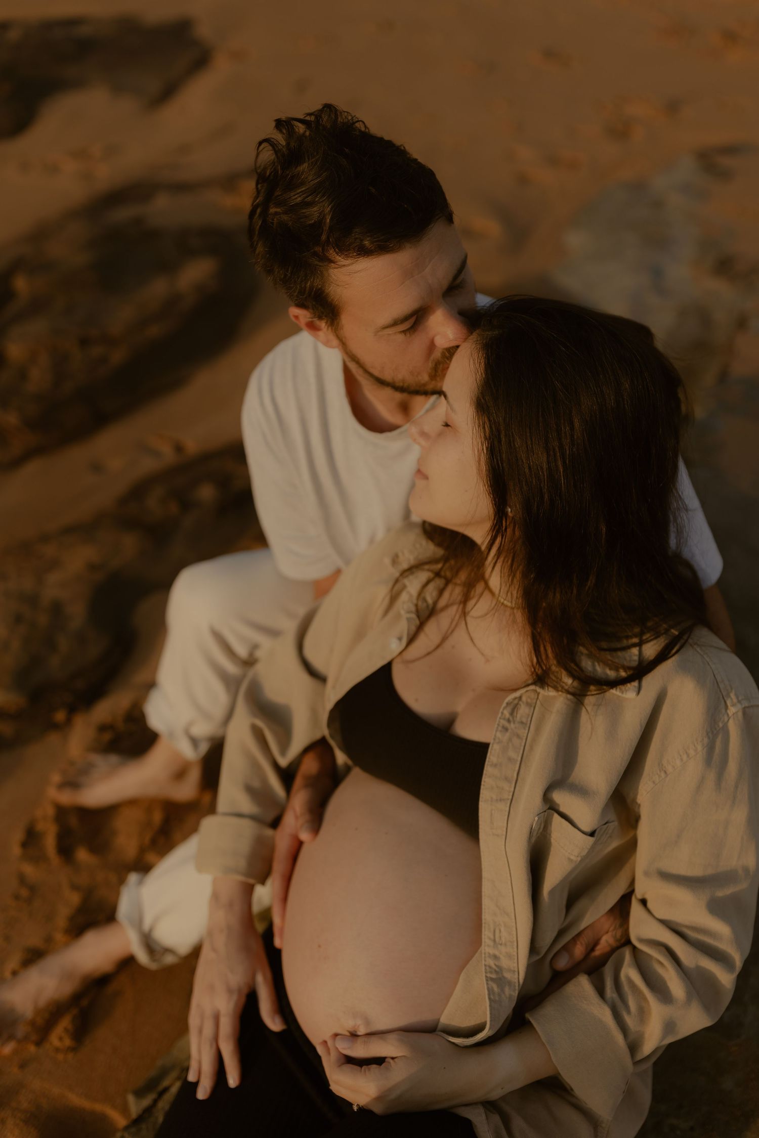 A romantic couple shares tender moments in a series of warm-toned photographs at sunset.