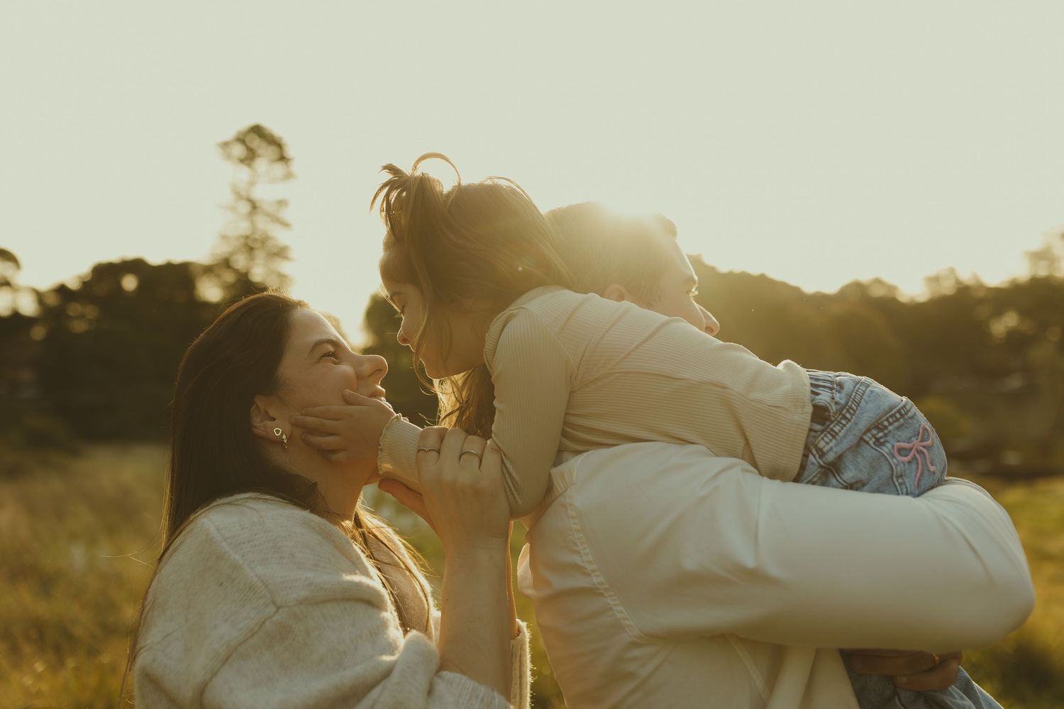 A series of romantic sunset photos showing intimate moments between two people in a golden field.