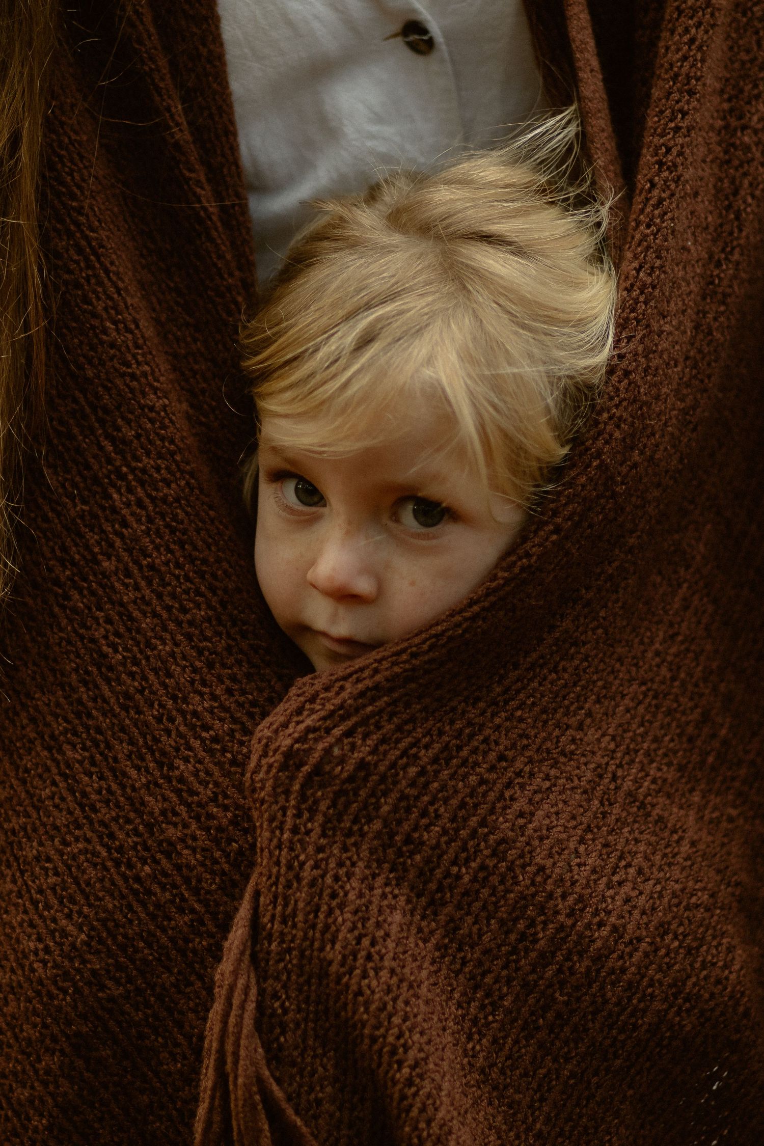 Close up detail of a brown knit sweater texture with soft lighting.