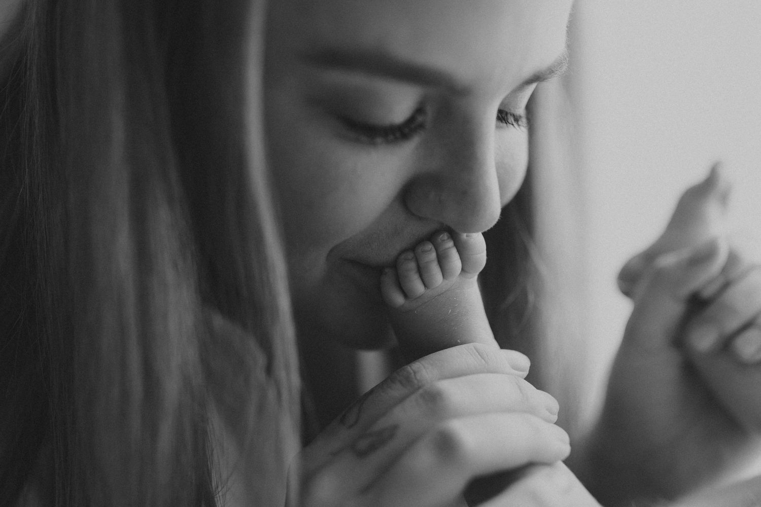 Intimate black and white portrait capturing a tender emotional moment.