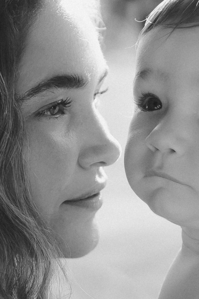 Close up black and white portrait of a parent and child in intimate moment with soft lighting.