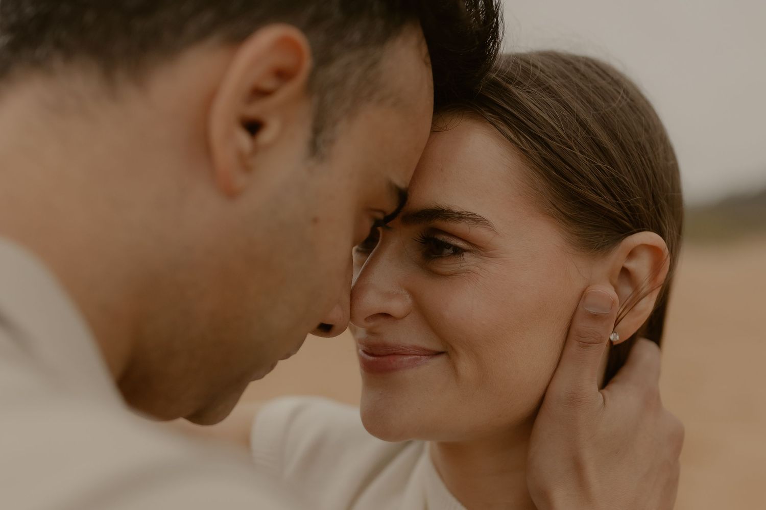 An intimate close-up portrait of a couple sharing a tender moment together.