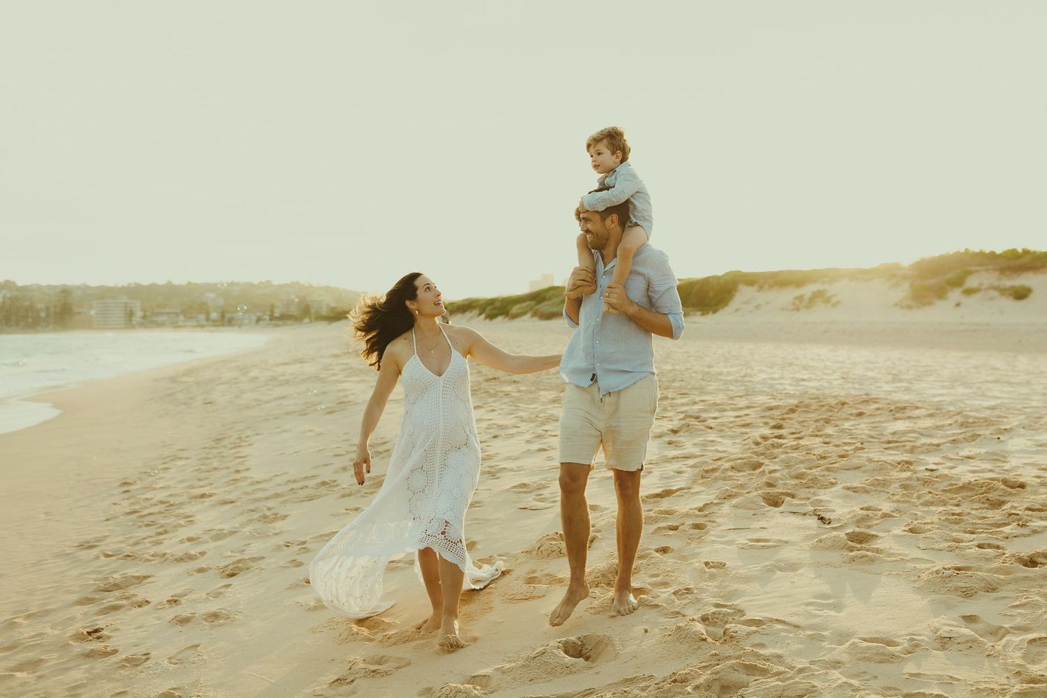 Joyful family moments captured while running and playing on a beach.