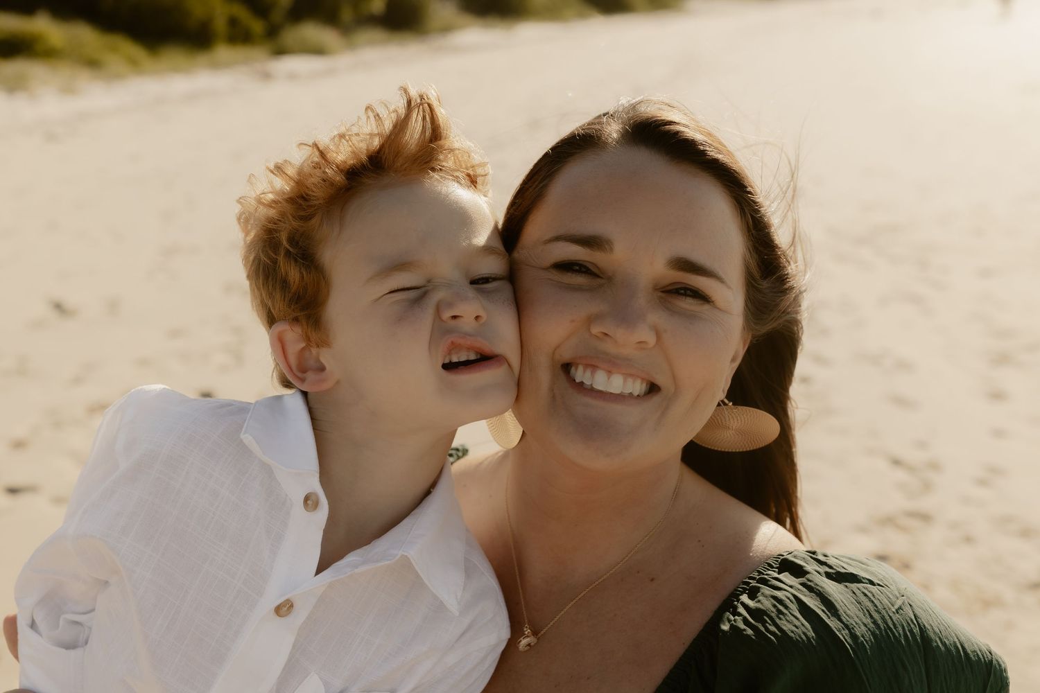 Close-up shots of joyful moments shared between family members at the beach.