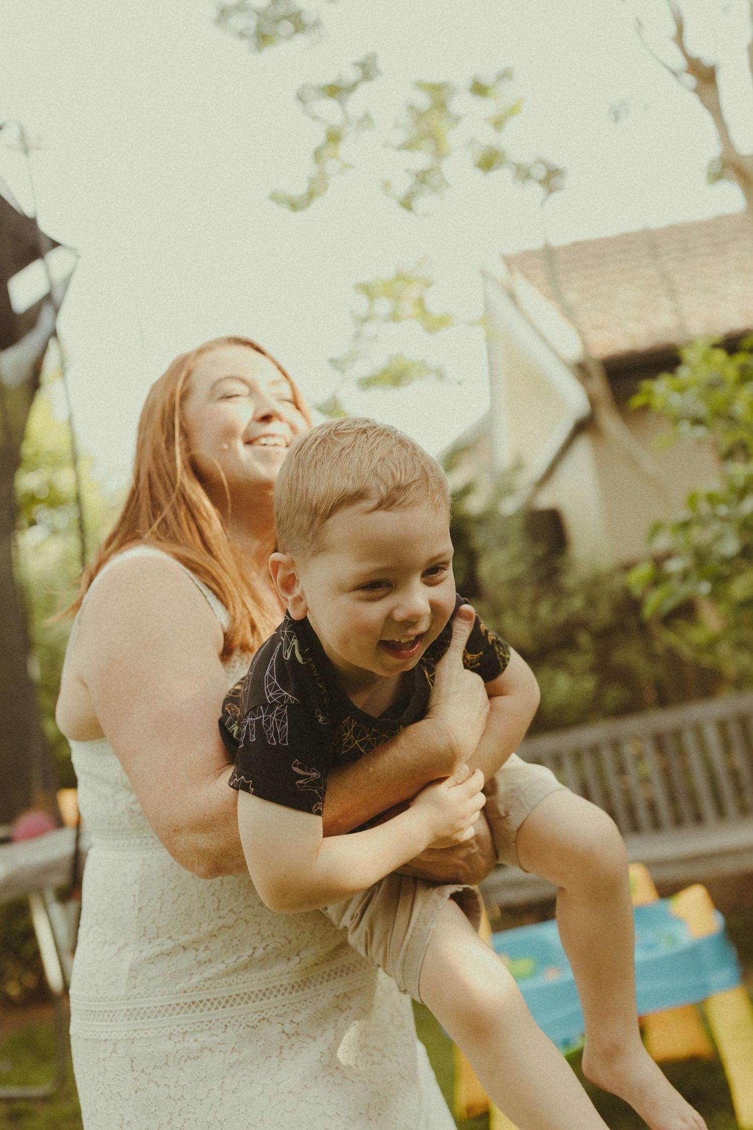 Joyful outdoor sequence showing laughter and embraces in warm summer lighting.