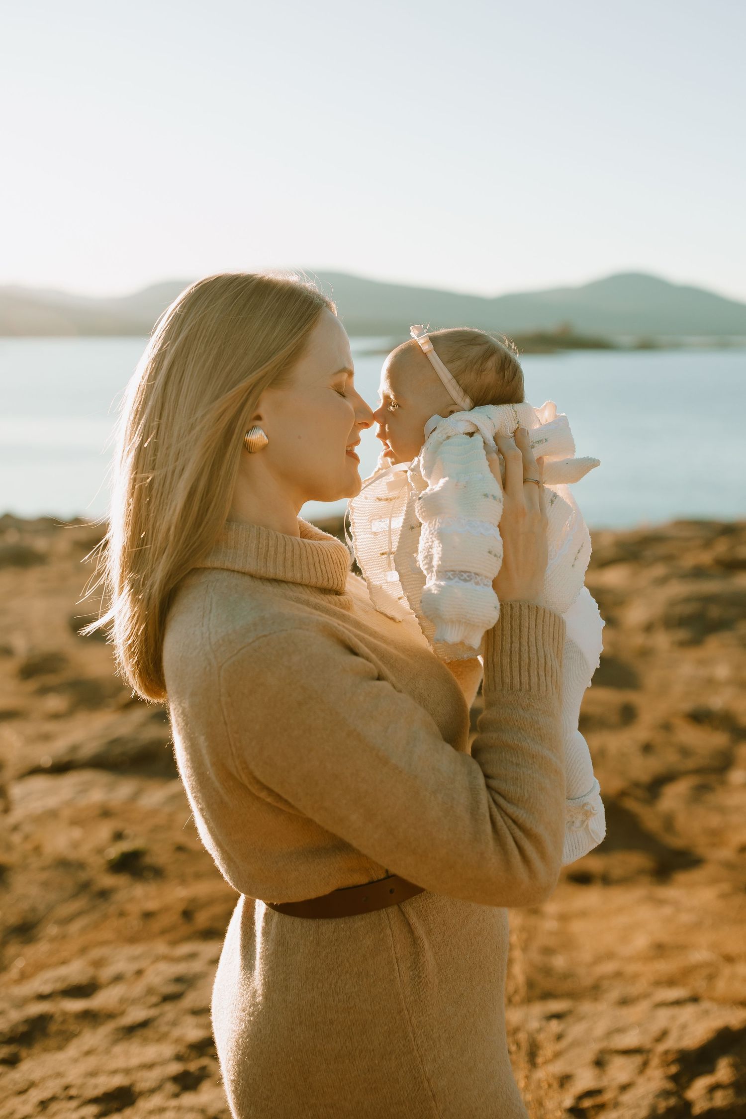 Series of loving parent-child embraces against a scenic coastal backdrop during golden hour.