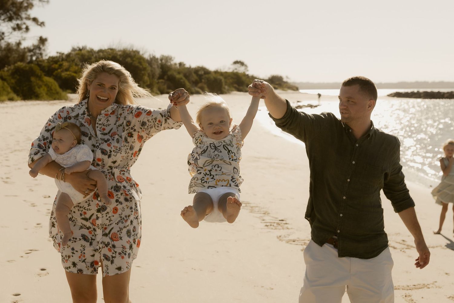 Family enjoying a carefree moment together on a scenic beach.